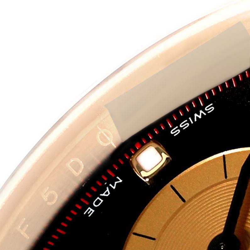This image shows a close-up of the dial's edge and indices of a Rolex Daytona 116508 Men's Yellow Gold Black Dial 116508 Men's Yellow Gold Black Dial watch, highlighting the "Swiss Made" label.