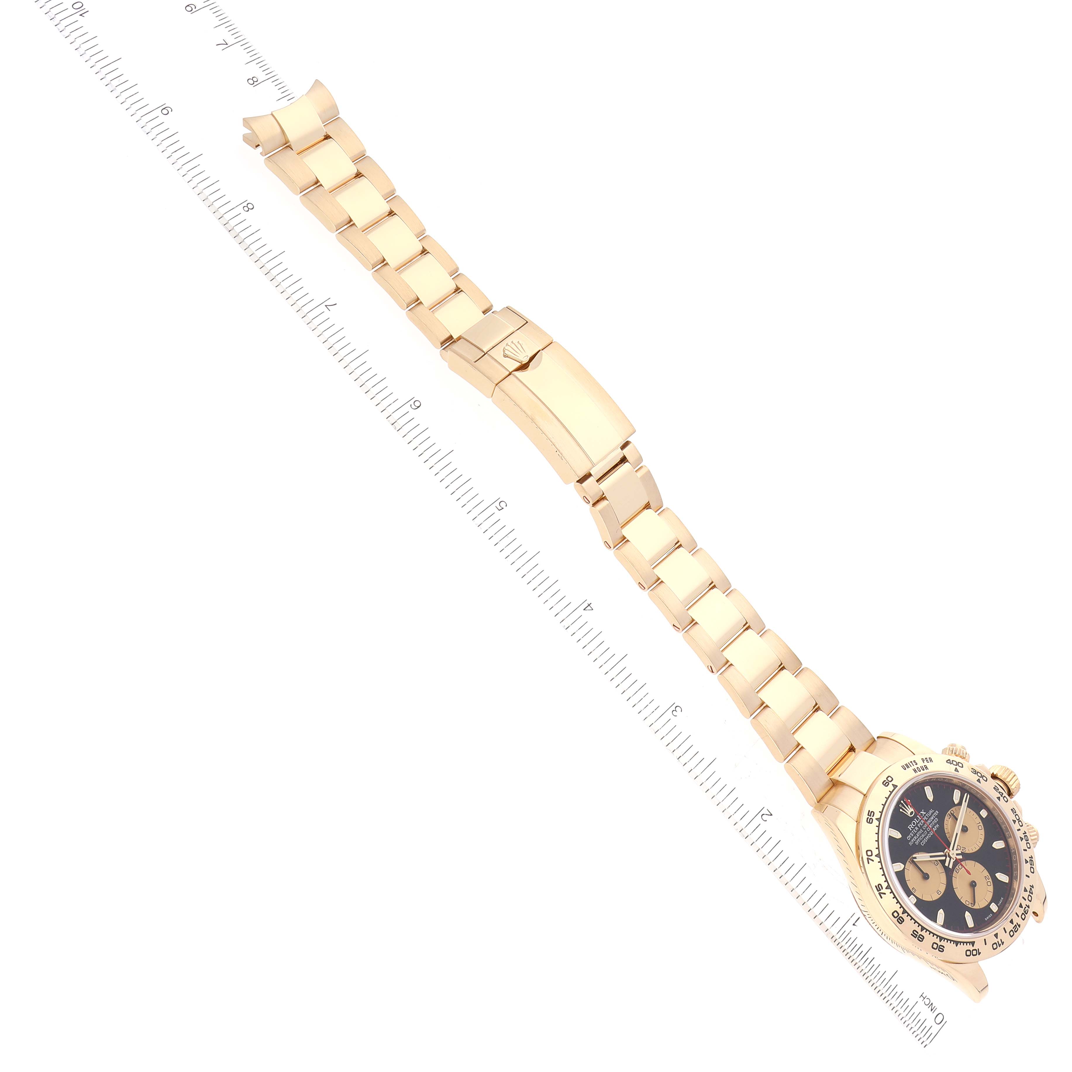 The image shows a Rolex Daytona 116508 Men's Yellow Gold Black Dial 116508 Men's Yellow Gold Black Dial watch laid flat, showcasing the face, bracelet, and clasp at an angled top-down view.