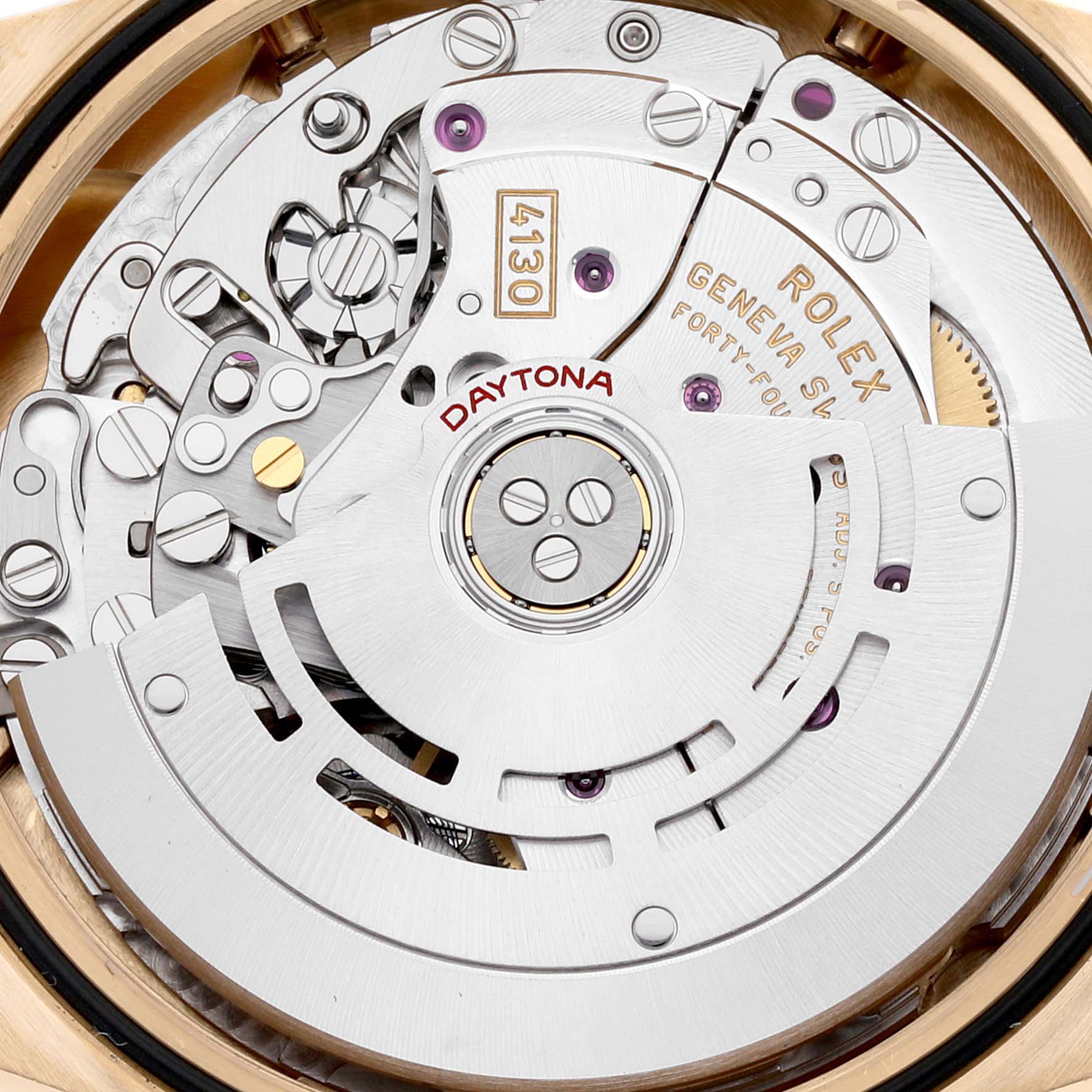 This image shows the movement and inner mechanism of a Rolex Daytona 116508 Men's Yellow Gold Black Dial 116508 Men's Yellow Gold Black Dial watch, including components like gears and inscriptions.