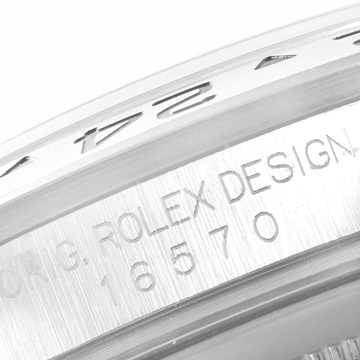 This image shows a close-up of the engraved bezel and the serial number of a Rolex Explorer 16570 Men's Stainless Steel White Dial 16570 Men's Stainless Steel White Dial model watch.