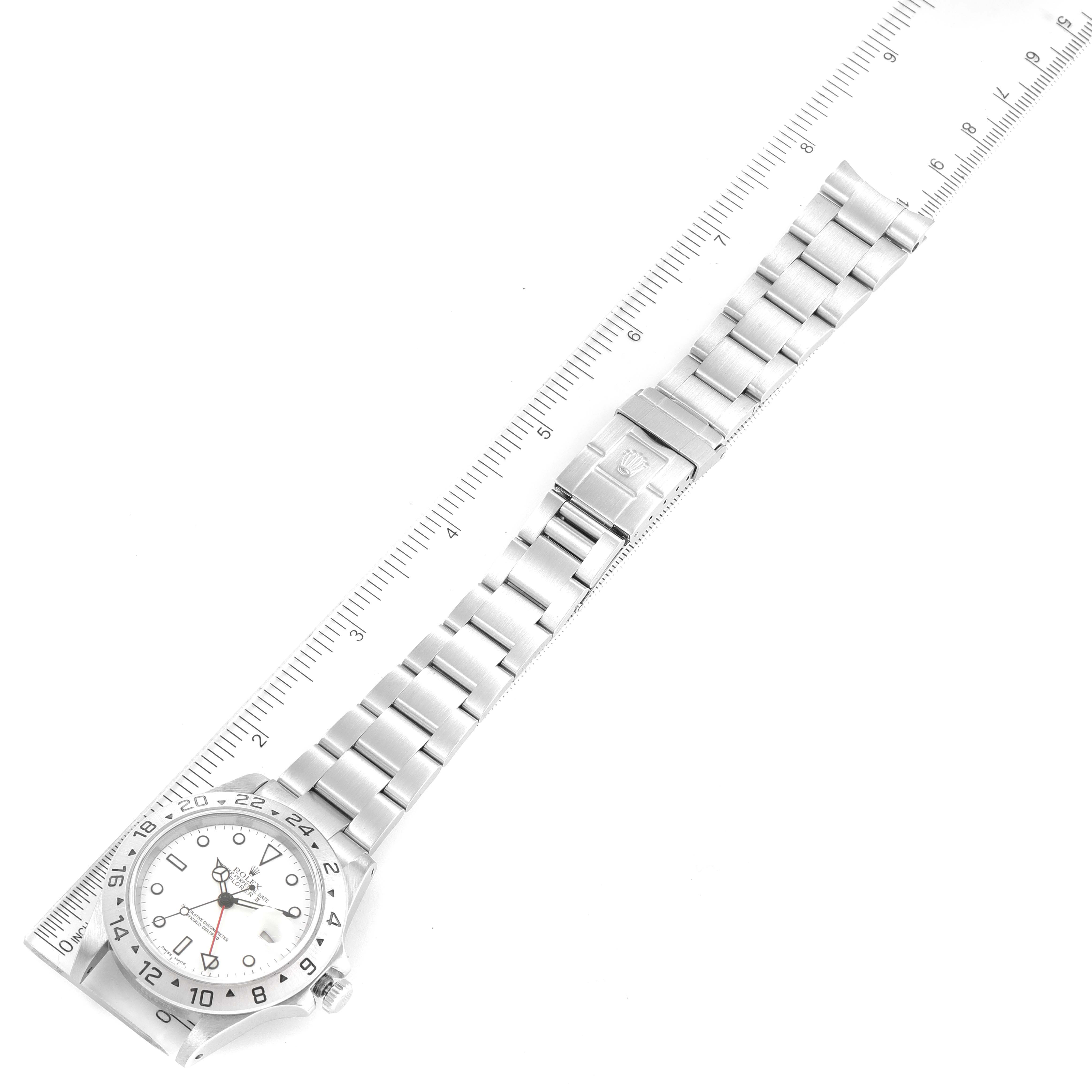 The image shows a top-down view of a Rolex Explorer 16570 Men's Stainless Steel White Dial 16570 Men's Stainless Steel White Dial watch with its bracelet fully extended next to a ruler.