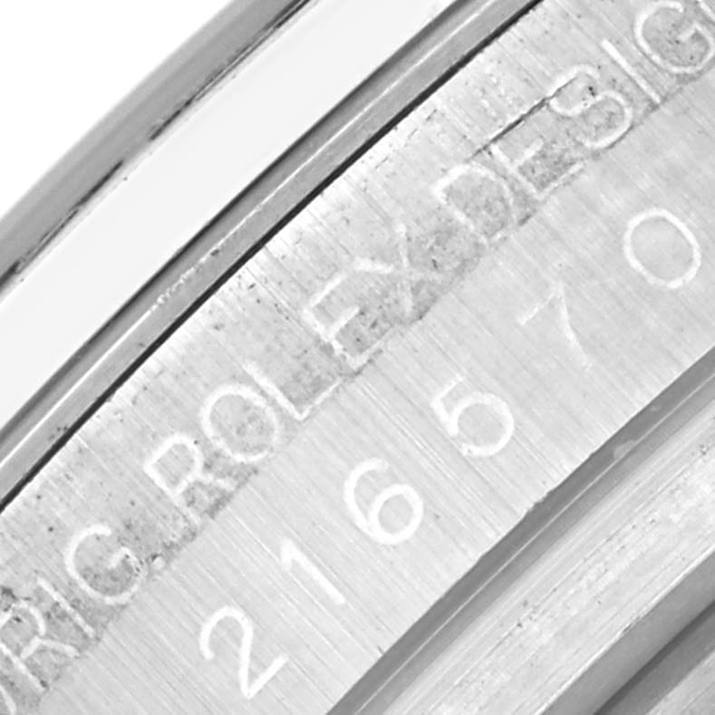 This close-up image shows the engraved inner bezel of a Rolex Explorer 216570 Men's Stainless Steel Black Dial 216570 Men's Stainless Steel Black Dial watch, focusing on the model number and brand name.