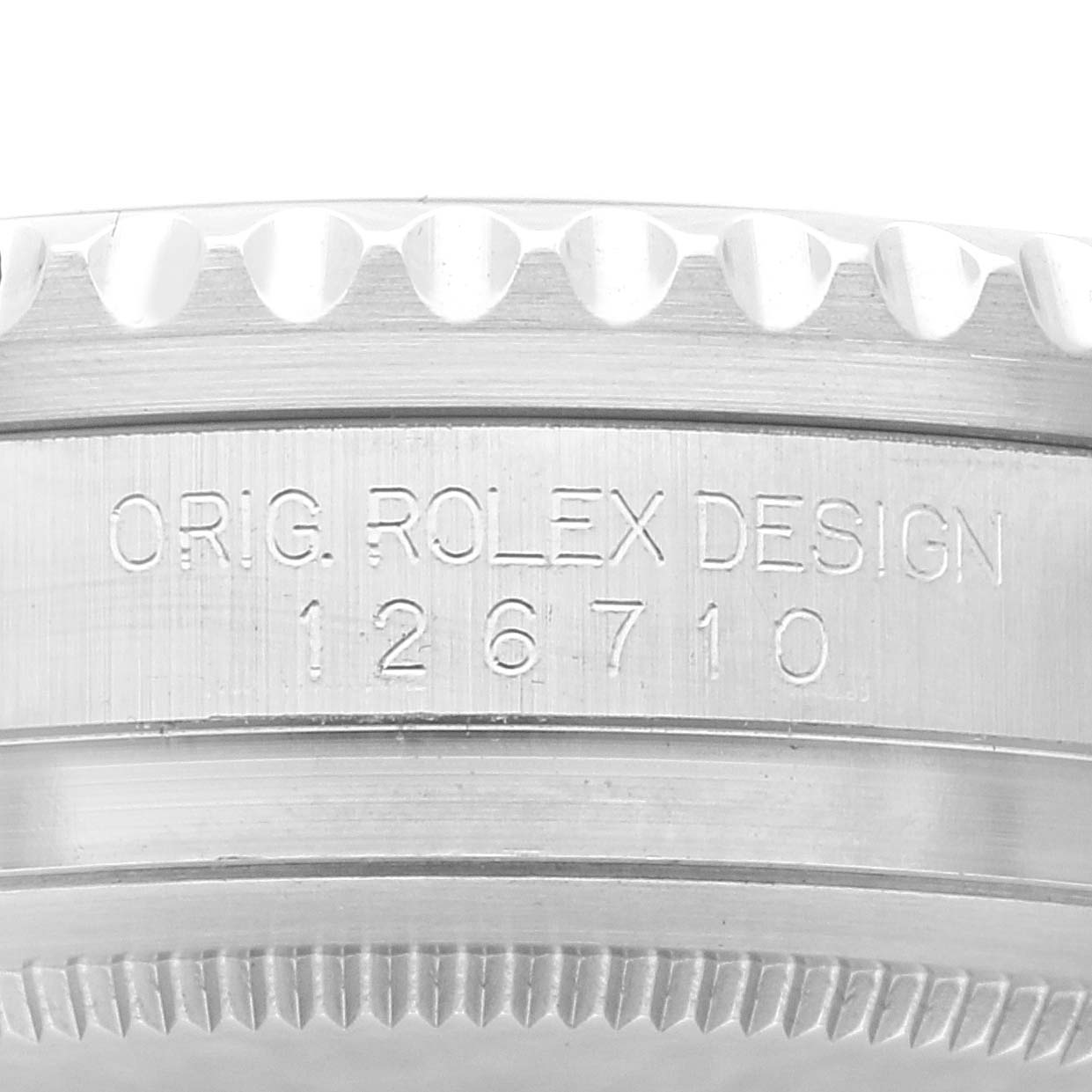 This close-up image shows the engraved model number and serrated edge of a Rolex GMT-Master 126710BLNR Men
s Stainless Steel Black Dial 126710BLNR Men
s Stainless Steel Black Dial watch case.