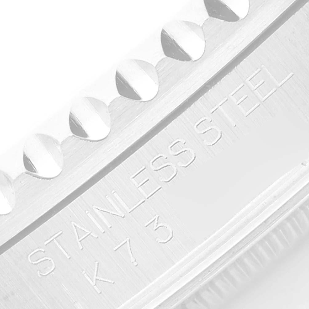 The image shows a close-up of the stainless steel case back and edge of the bezel of a Rolex GMT-Master 16710 Men's Stainless Steel Black Dial 16710 Men's Stainless Steel Black Dial watch.