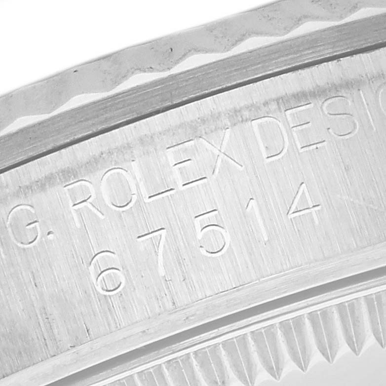 The image shows the side engraving of a Mid-Size Rolex watch case with model number details.