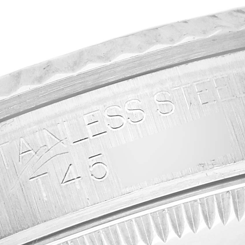 The image shows a close-up of the stainless steel bezel with engravings on the Rolex Mid-Size 67514 Women's Stainless Steel Silver Dial 67514 Women's Stainless Steel Silver Dial watch.