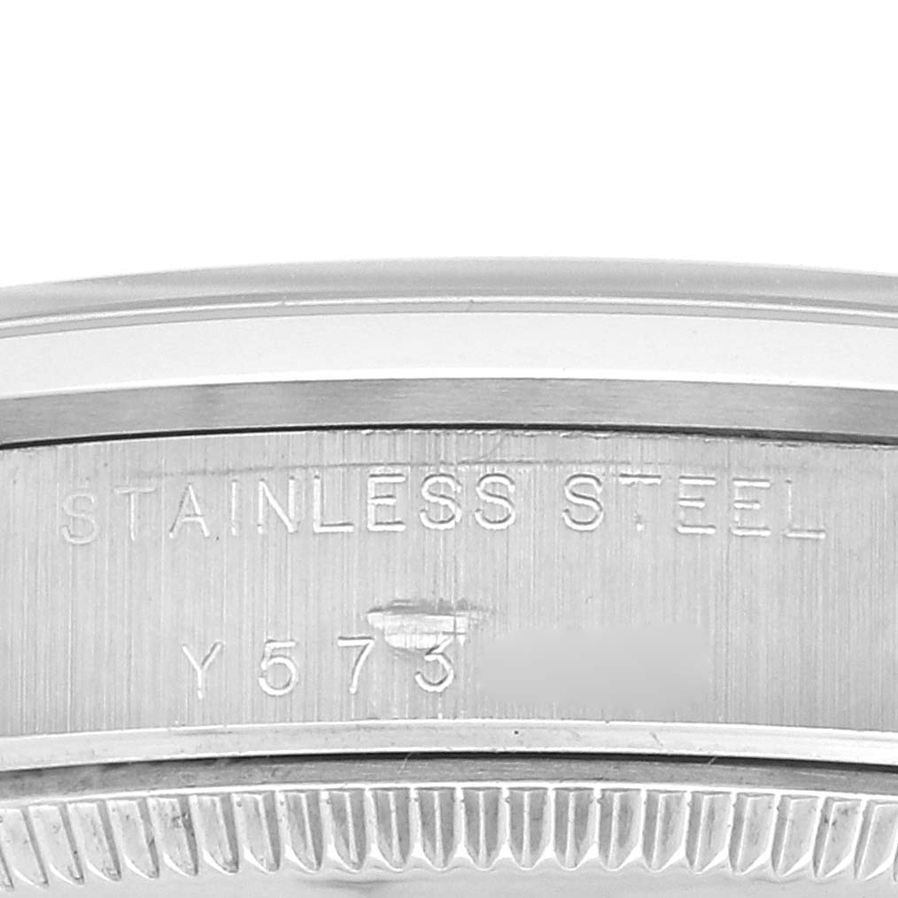 This close-up image shows the side engraving on the stainless steel case back of a Rolex Mid-Size 77080 Women
s Stainless Steel White Dial 77080 Women
s Stainless Steel White Dial model watch.