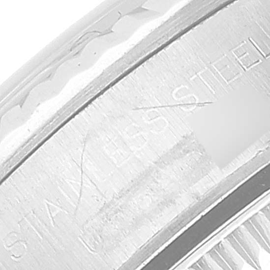 This close-up image shows the engraved details on the side of a Rolex Oyster Perpetual 67194 Women
s Stainless Steel Blue Dial 67194 Women
s Stainless Steel Blue Dial watch case, focusing on the text "STAINLESS STEEL."