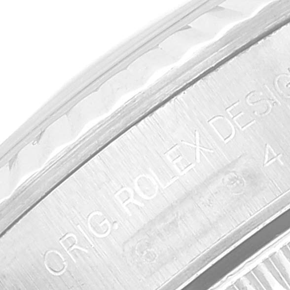 The image shows a close-up of the engraved bezel of a Rolex Oyster Perpetual 67194 Women
s Stainless Steel Blue Dial 67194 Women
s Stainless Steel Blue Dial watch.