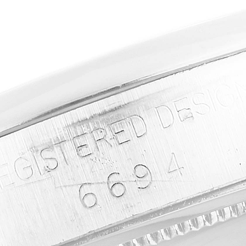 This image shows a close-up of the side engraving on the Rolex Vintage Collection 6694 Men's Stainless Steel Black Dial 6694 Men's Stainless Steel Black Dial watch.