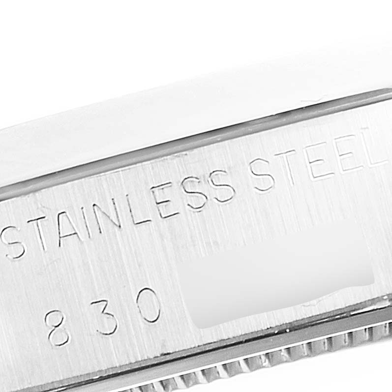 This close-up image shows the side of the stainless steel case of a Rolex Vintage Collection 6694 Men's Stainless Steel Silver Dial 6694 Men's Stainless Steel Silver Dial watch, featuring engraved text.