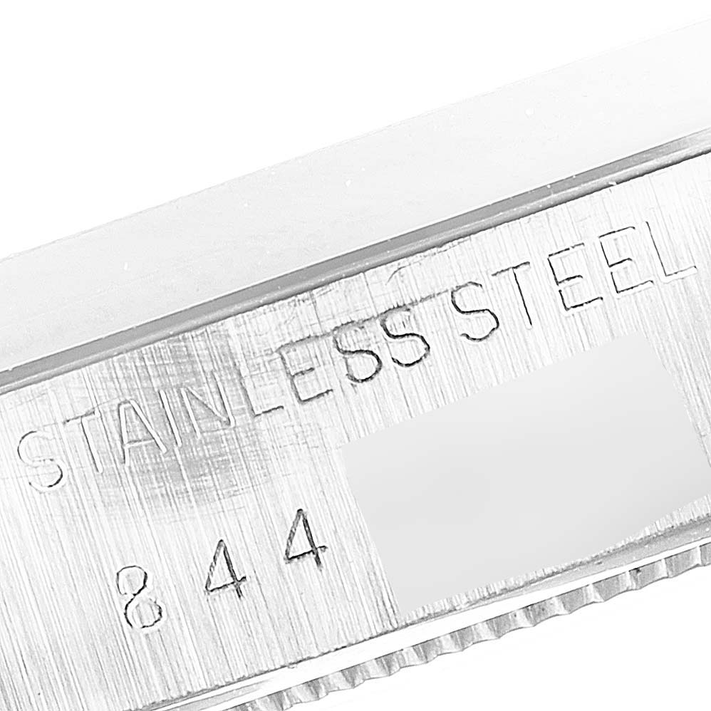 The image shows a close-up of the stainless steel casing with engravings on a Rolex Vintage Collection 6694 Men's Stainless Steel Silver Dial 6694 Men's Stainless Steel Silver Dial model watch.