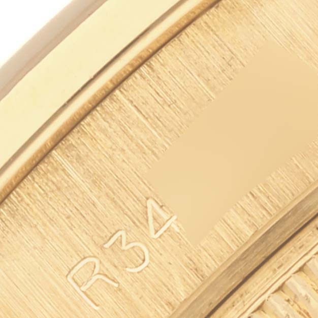 The image shows a close-up of the Rolex Pearlmaster's gold bracelet with visible part numbers engraved.