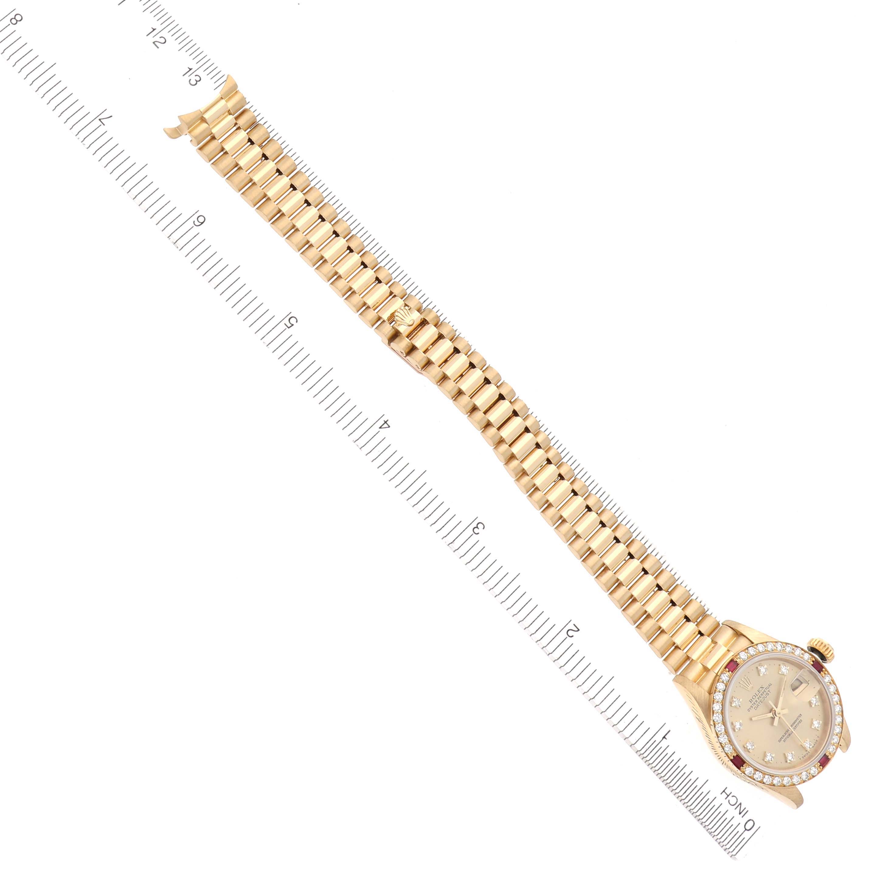 The Rolex Pearlmaster watch is shown from a top-down angle, displaying its full bracelet and face against a ruler.