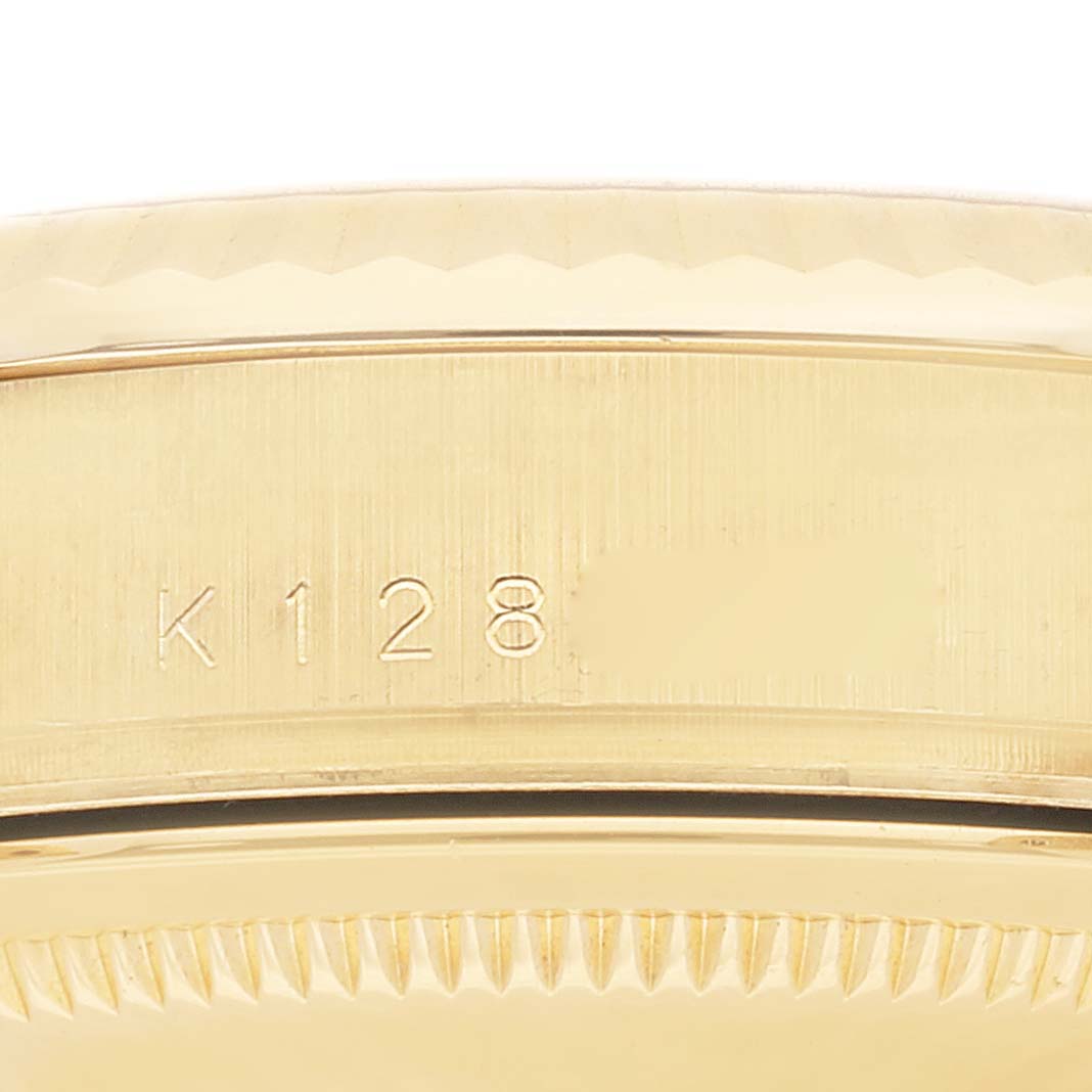 This image shows a close-up of the engraving and bezel details on the side of a Rolex President 118238A Men's Yellow Gold Black Dial 118238A Men's Yellow Gold Black Dial model watch.