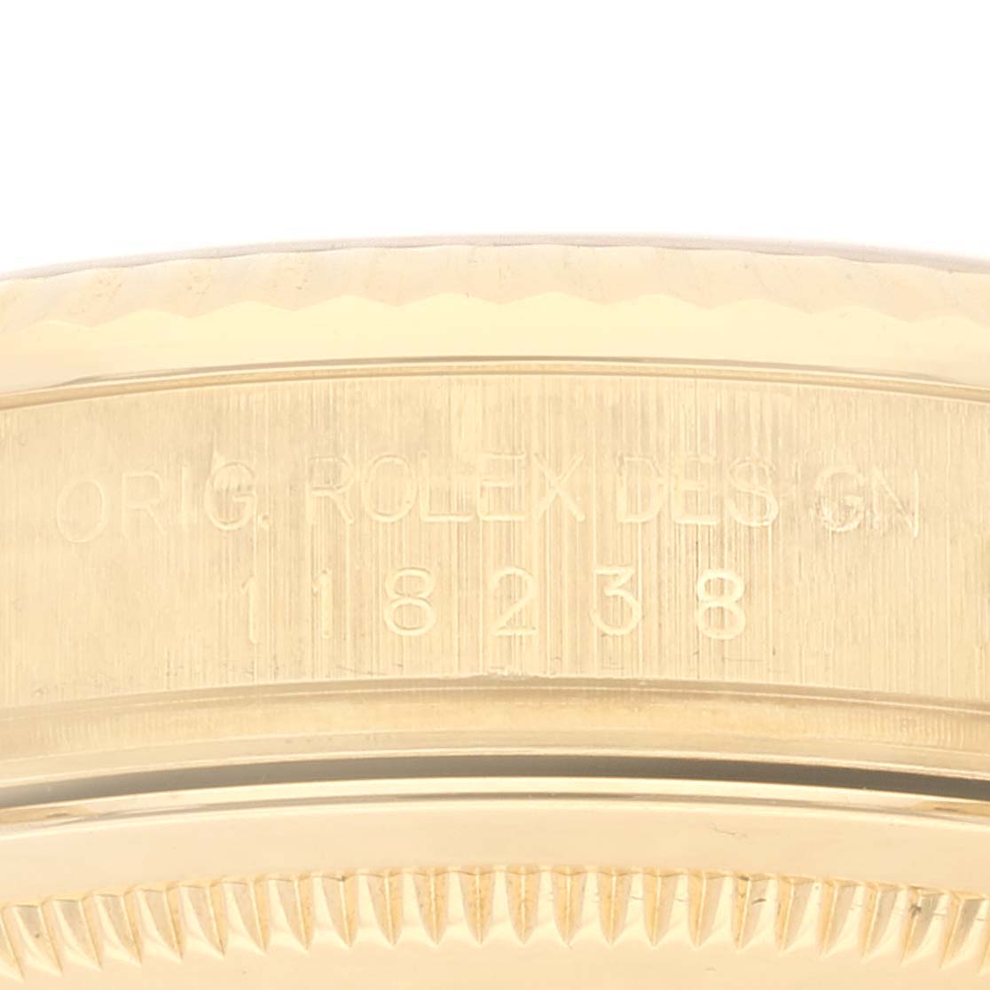 This image shows a close-up of the serial number engraving on the side of a Rolex President 118238A Men's Yellow Gold Black Dial 118238A Men's Yellow Gold Black Dial watch case.