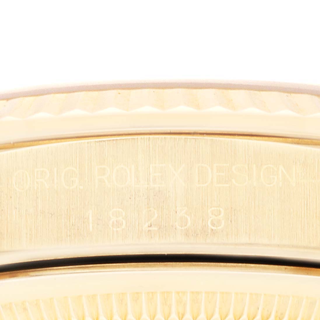 The image shows a close-up of the engraved side of a gold Rolex President 18238 Men's Yellow Gold Champagne Dial 18238 Men's Yellow Gold Champagne Dial watch.