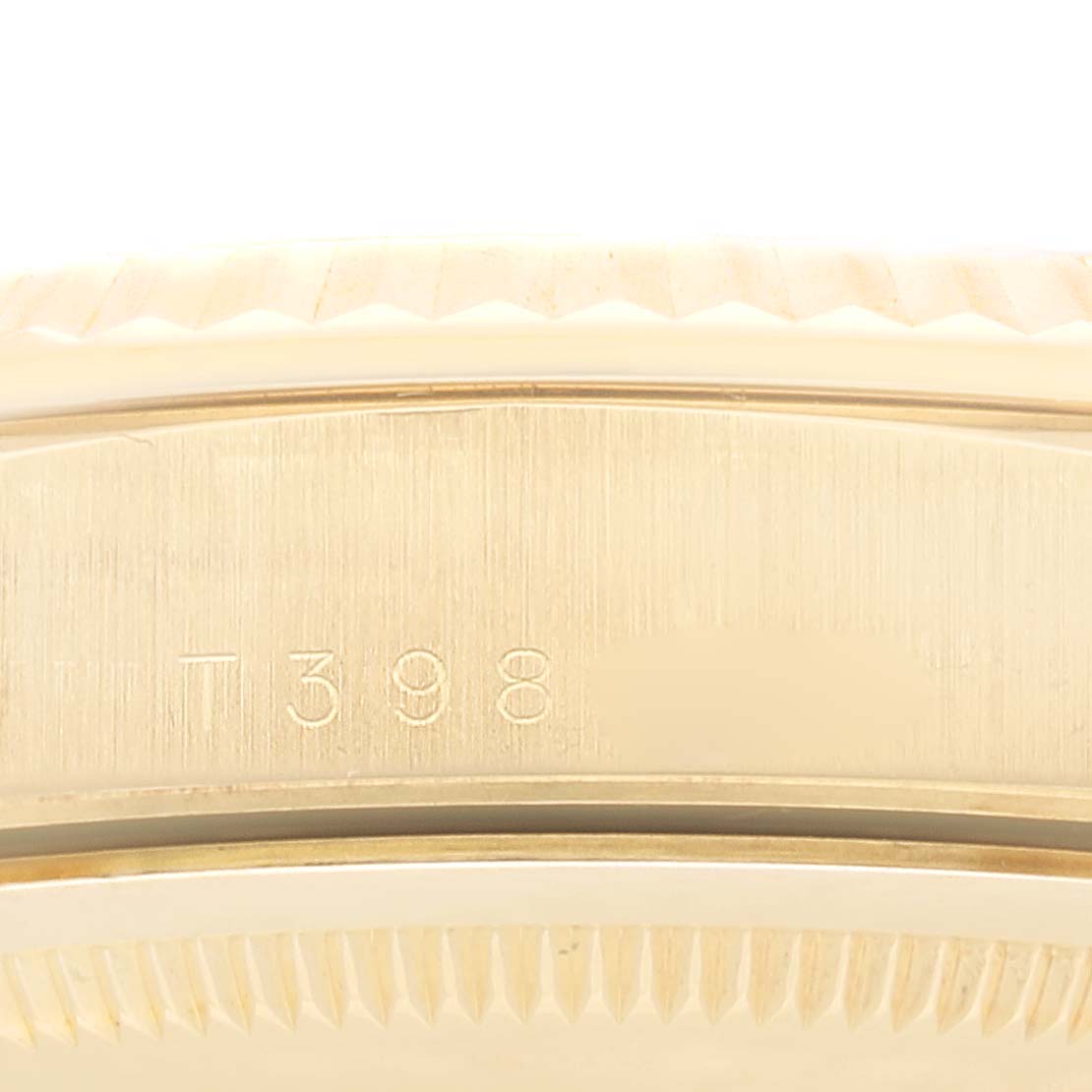 This image shows a close-up of the side of the Rolex President 18238 Men's Yellow Gold Champagne Dial 18238 Men's Yellow Gold Champagne Dial model, highlighting parts of the case and bezel.