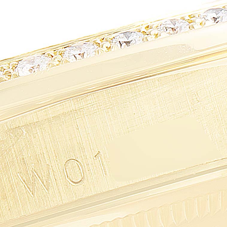 This close-up angle of the Rolex President 18388 Men's Yellow Gold Champagne Dial 18388 Men's Yellow Gold Champagne Dial model watch shows the bezel with diamonds and part of the engraved case.