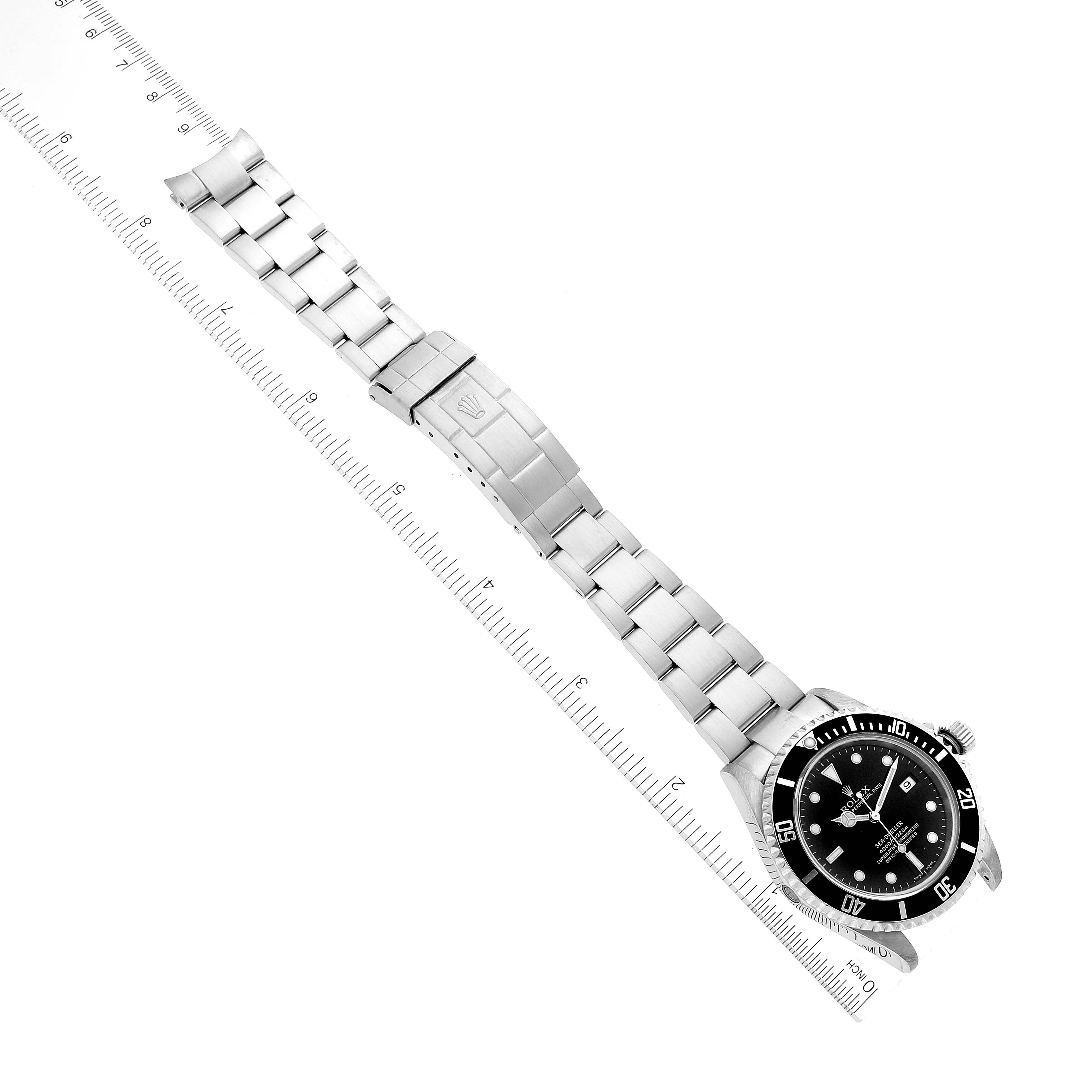 The Rolex Sea-Dweller 16600T Men
s Stainless Steel Black Dial 16600T Men
s Stainless Steel Black Dial watch is displayed at a diagonal angle, showing the full bracelet, clasp, and face with a measuring ruler.