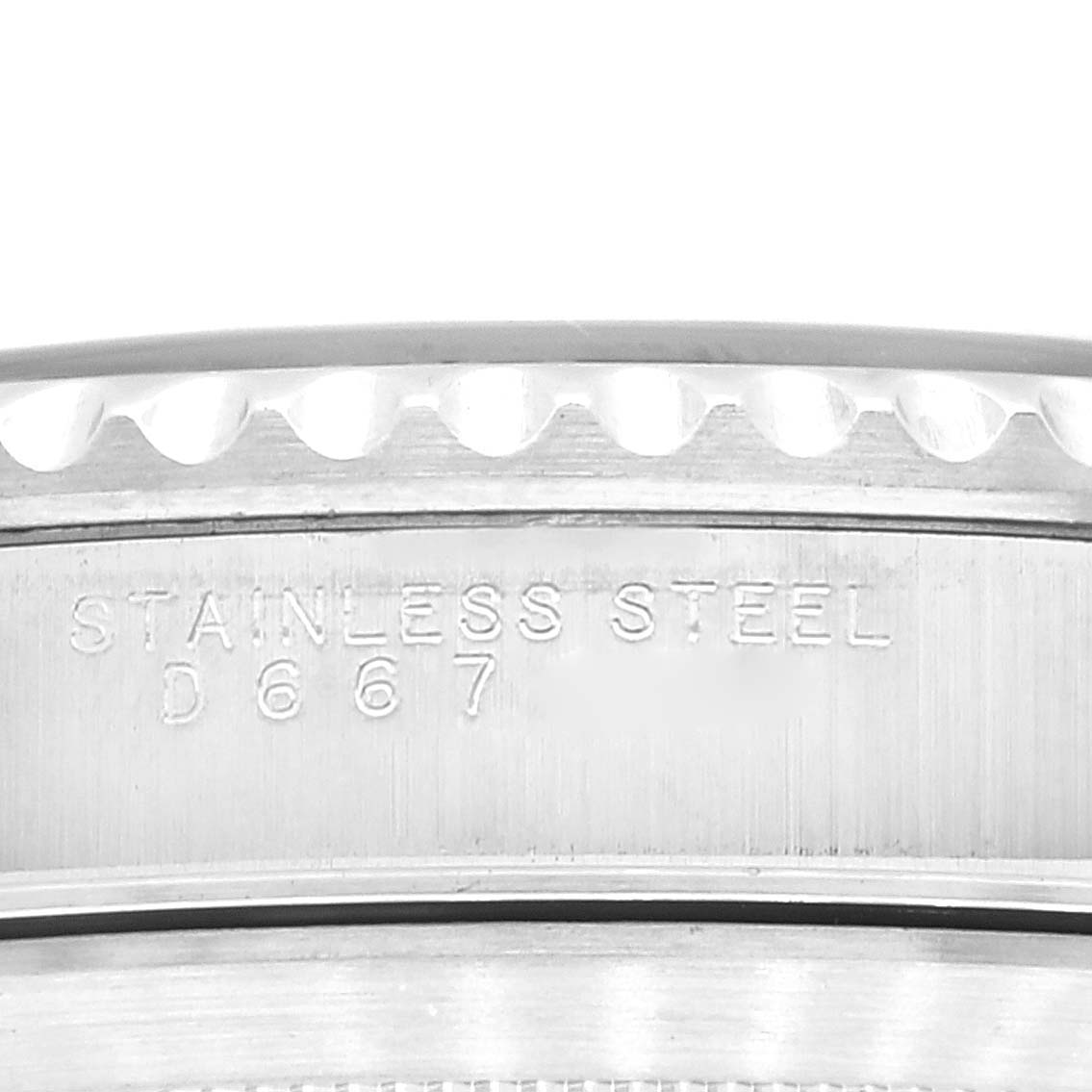 This close-up image shows the side of a Rolex Submariner 14060M Men's Stainless Steel Black Dial 14060M Men's Stainless Steel Black Dial watch, displaying the "Stainless Steel" engraving and watch serial number.