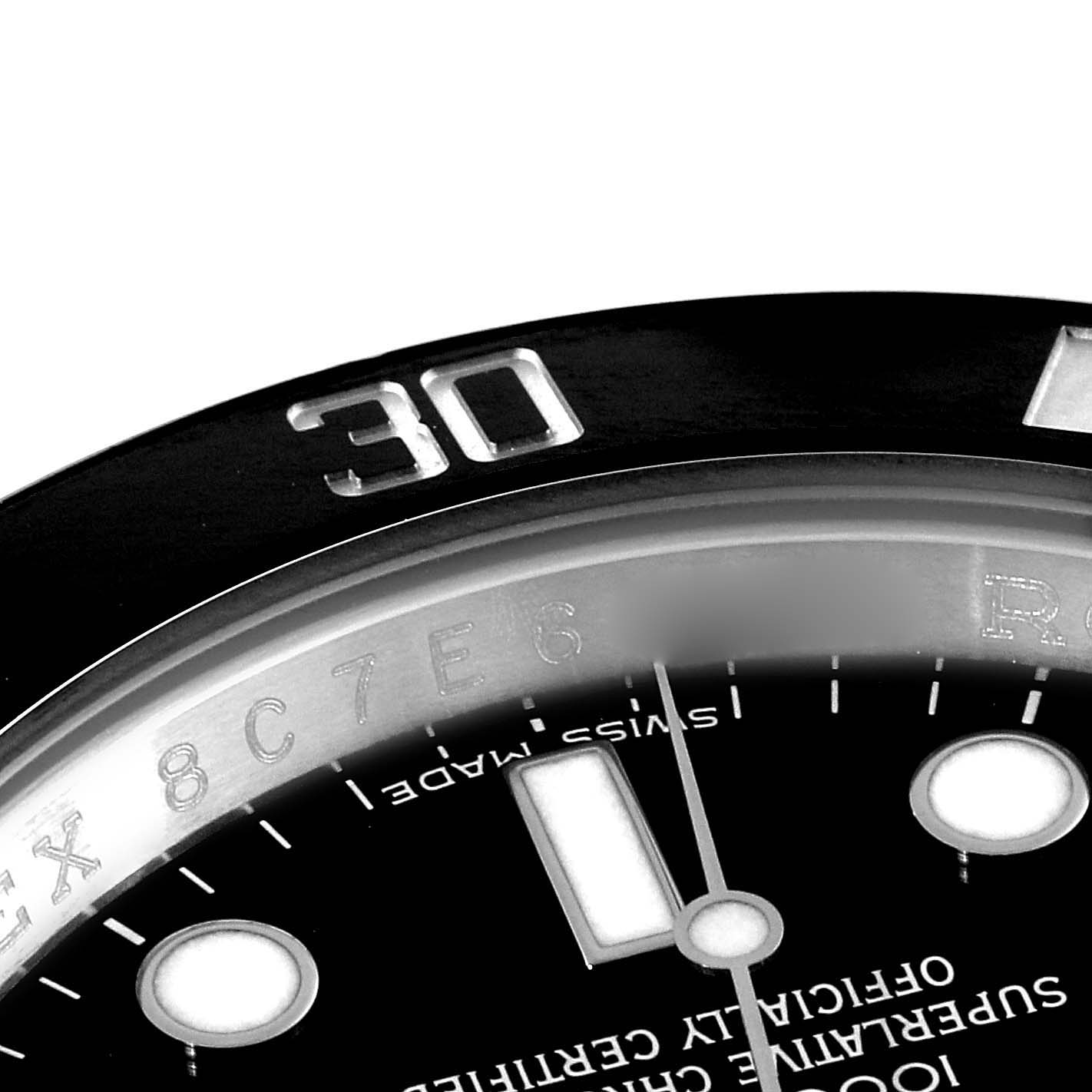 This close-up angle of the Rolex Submariner 116610 Men's Stainless Steel Black Dial 116610 Men's Stainless Steel Black Dial watch shows part of the bezel, dial, and some engravings.
