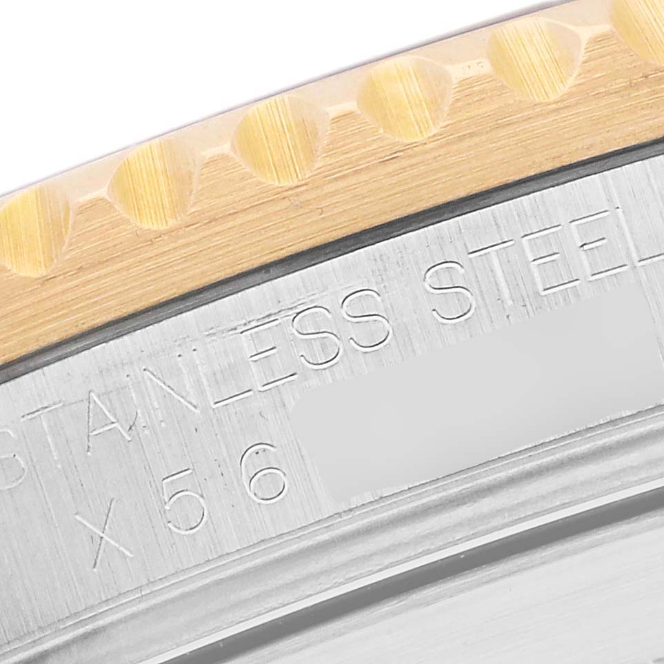 The image shows a close-up of the bezel and engraved case edge of the Rolex Submariner 16613 Men's Steel and Gold (two tone) Black Dial 16613 Men's Steel and Gold (two tone) Black Dial.
