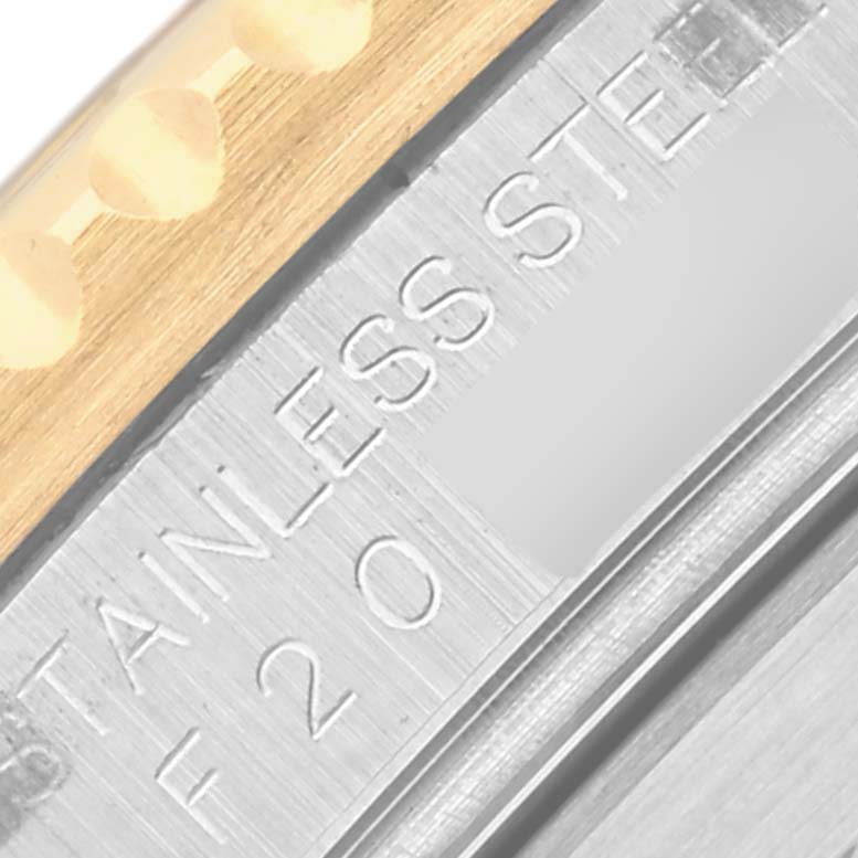 The image shows a detailed view of the stainless steel part and gold band of a Rolex Submariner 16613 Men's Steel and Gold (two tone) Blue Dial 16613 Men's Steel and Gold (two tone) Blue Dial watch.