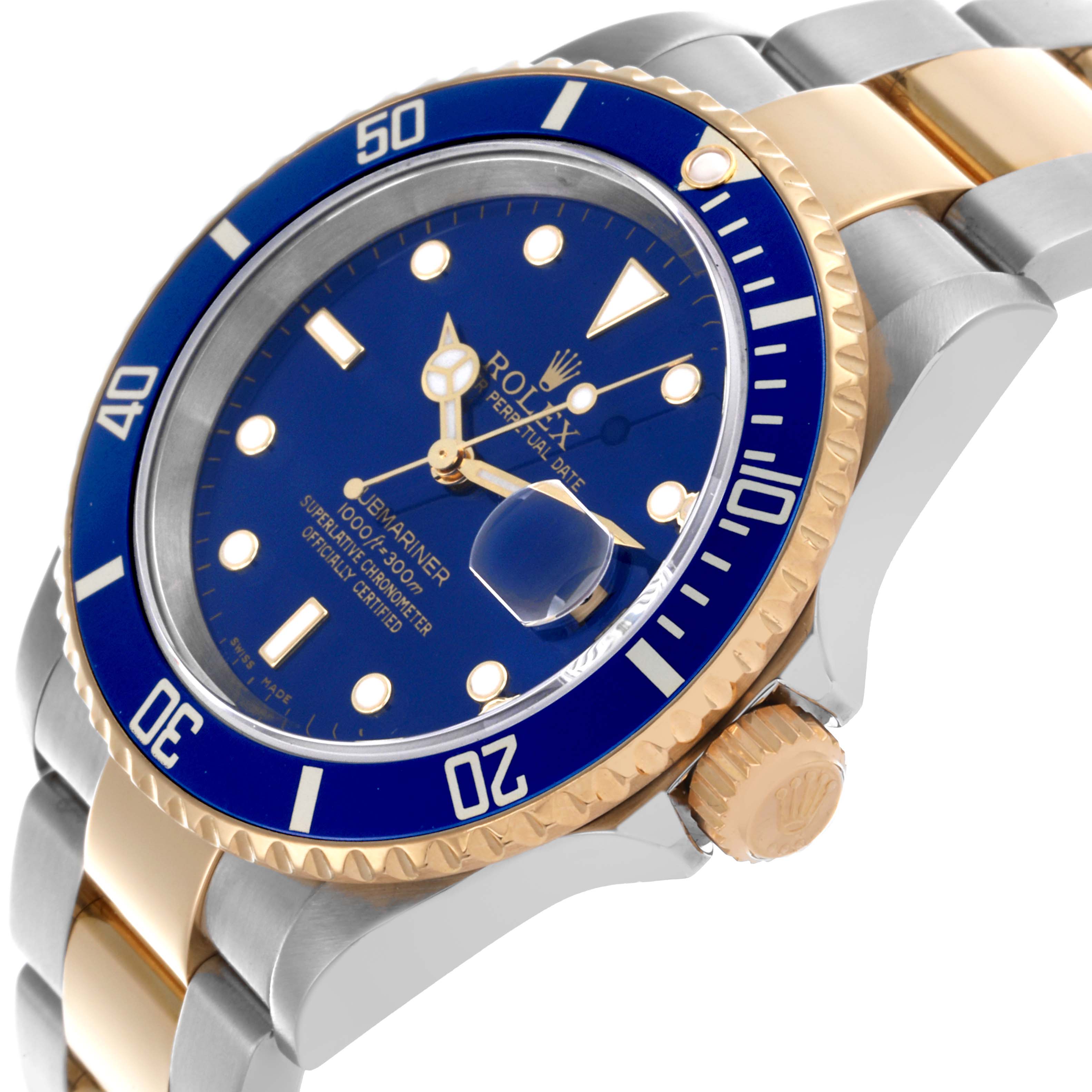 The Rolex Submariner 16613 Men's Steel and Gold (two tone) Blue Dial 16613 Men's Steel and Gold (two tone) Blue Dial is shown at an angle highlighting the blue dial, bezel, two-tone bracelet, and crown with cyclops lens.