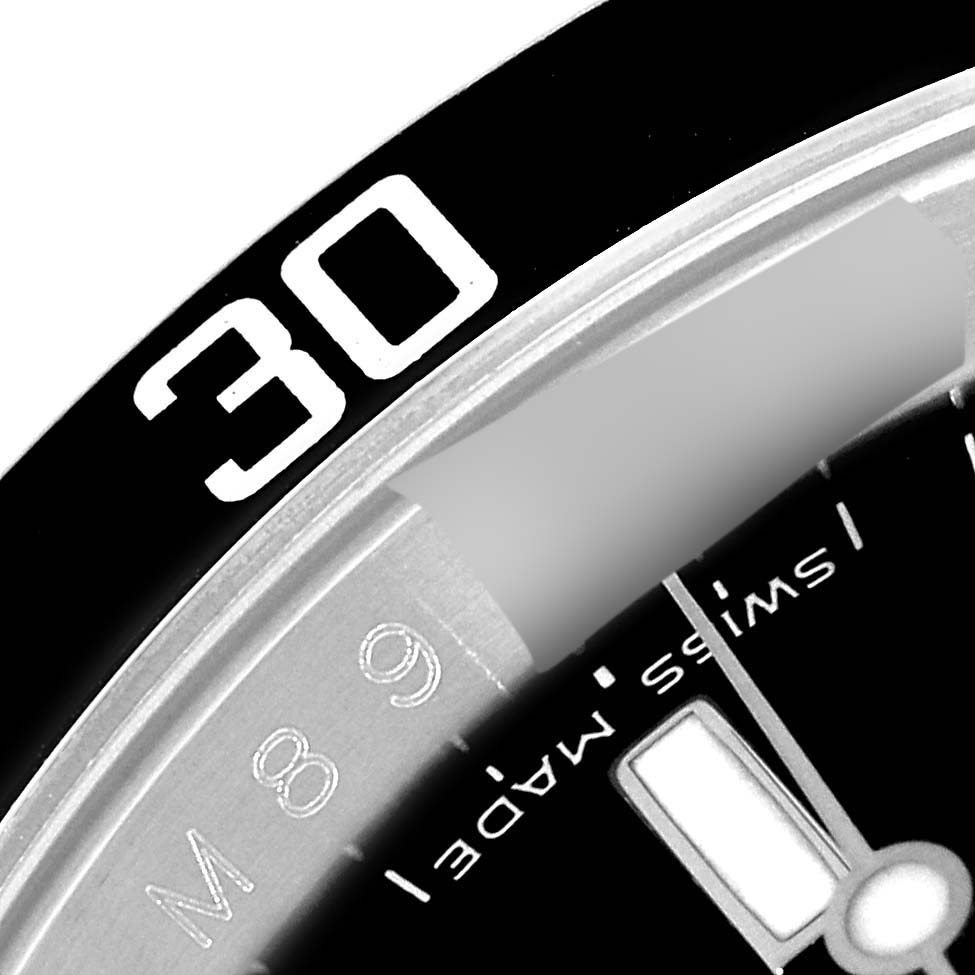 The image shows a close-up of the bezel and part of the dial on a Rolex Submariner 16610 Men's Stainless Steel Black Dial 16610 Men's Stainless Steel Black Dial watch.