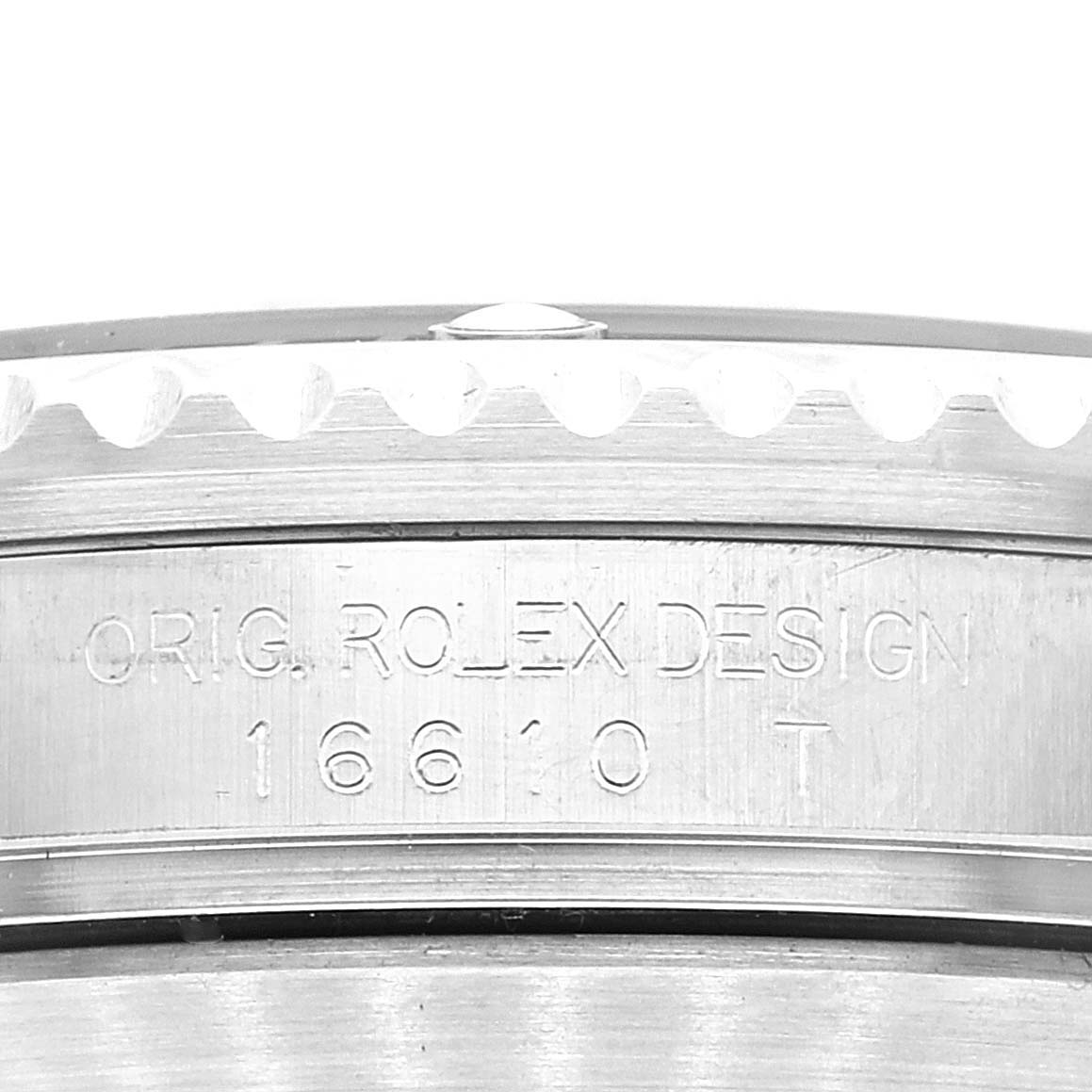 The image shows a close-up of the case side of a Rolex Submariner 16610 Men
s Stainless Steel Black Dial 16610 Men
s Stainless Steel Black Dial, highlighting the "ORIG. ROLEX DESIGN 16610 T" engraving.
