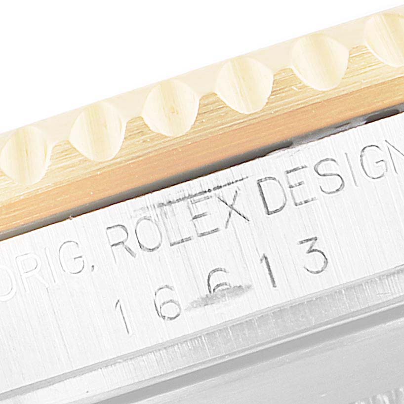 This close-up angle shows the side engraving with the model number on a Rolex Submariner 16613 Men's Steel and Gold (two tone) Champagne Dial 16613 Men's Steel and Gold (two tone) Champagne Dial.