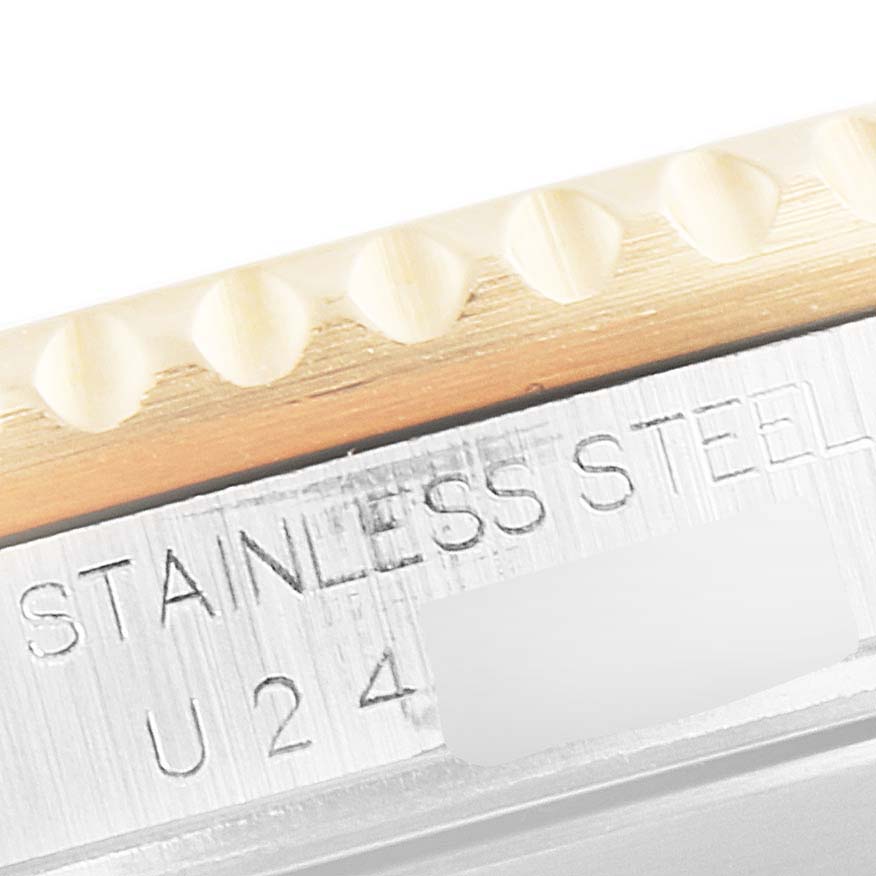 The image shows a close-up of a stainless steel side with engraving on a Rolex Submariner 16613 Men's Steel and Gold (two tone) Champagne Dial 16613 Men's Steel and Gold (two tone) Champagne Dial watch.