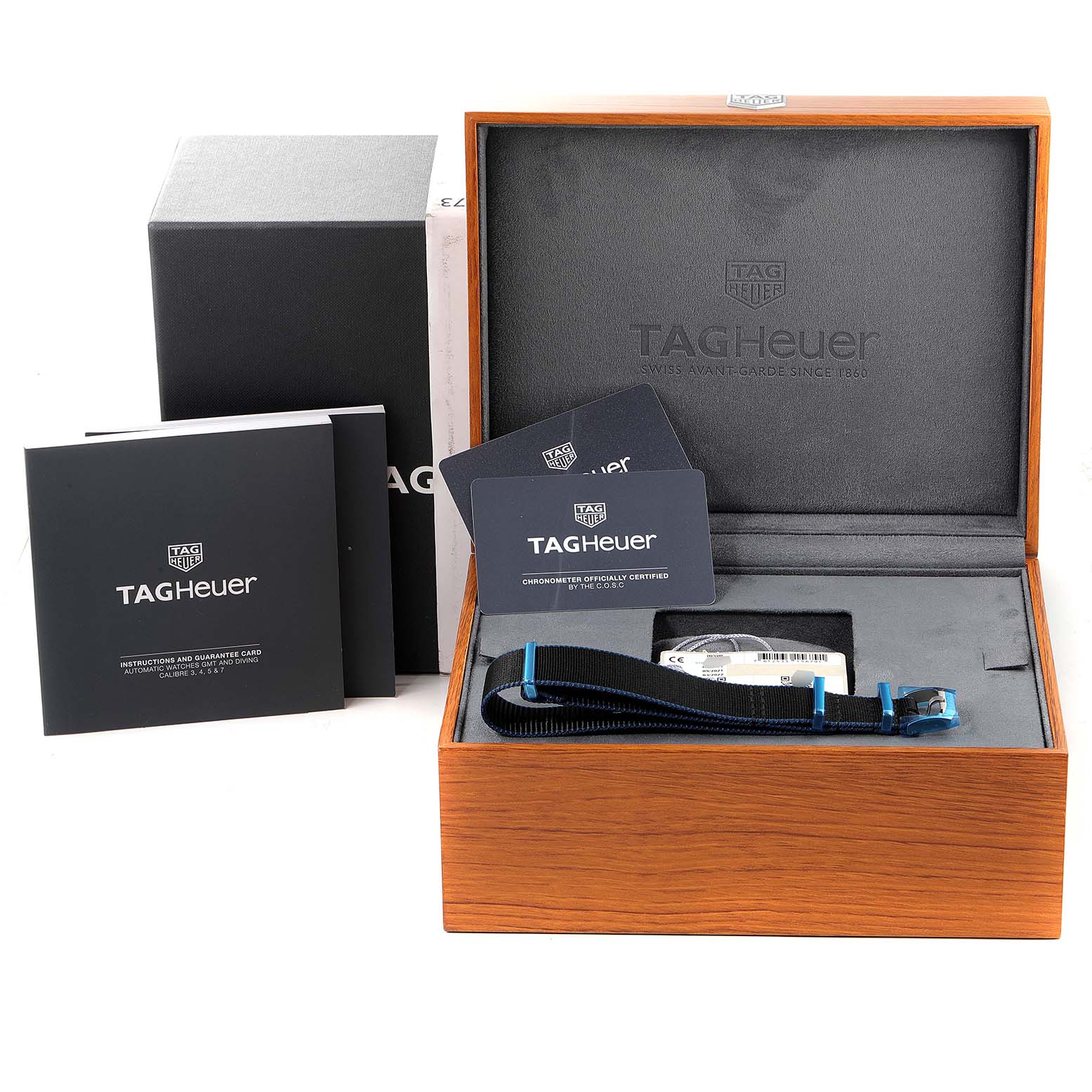 The image shows the packaging, manual, warranty cards, and additional strap for a Tag Heuer Autavia WBE5116.EB0173 Men's Stainless Steel Blue Dial WBE5116.EB0173 Men's Stainless Steel Blue Dial watch.