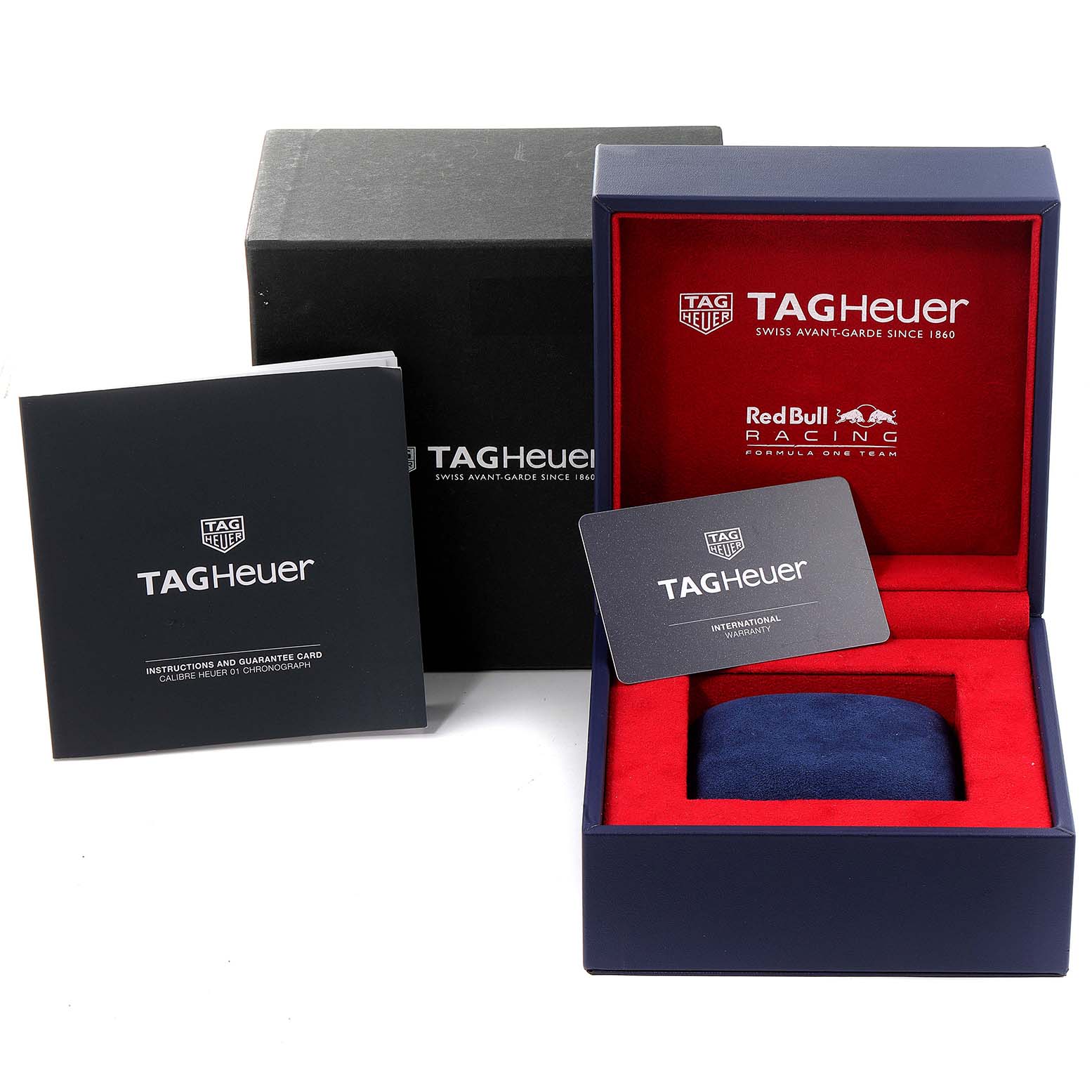 This image shows the packaging and accessories for a Tag Heuer Carrera CAR2A1K.BA0703 Men
s Stainless Steel Blue Dial CAR2A1K.BA0703 Men
s Stainless Steel Blue Dial watch, including boxes, a pillow cushion, manuals, and a warranty card.