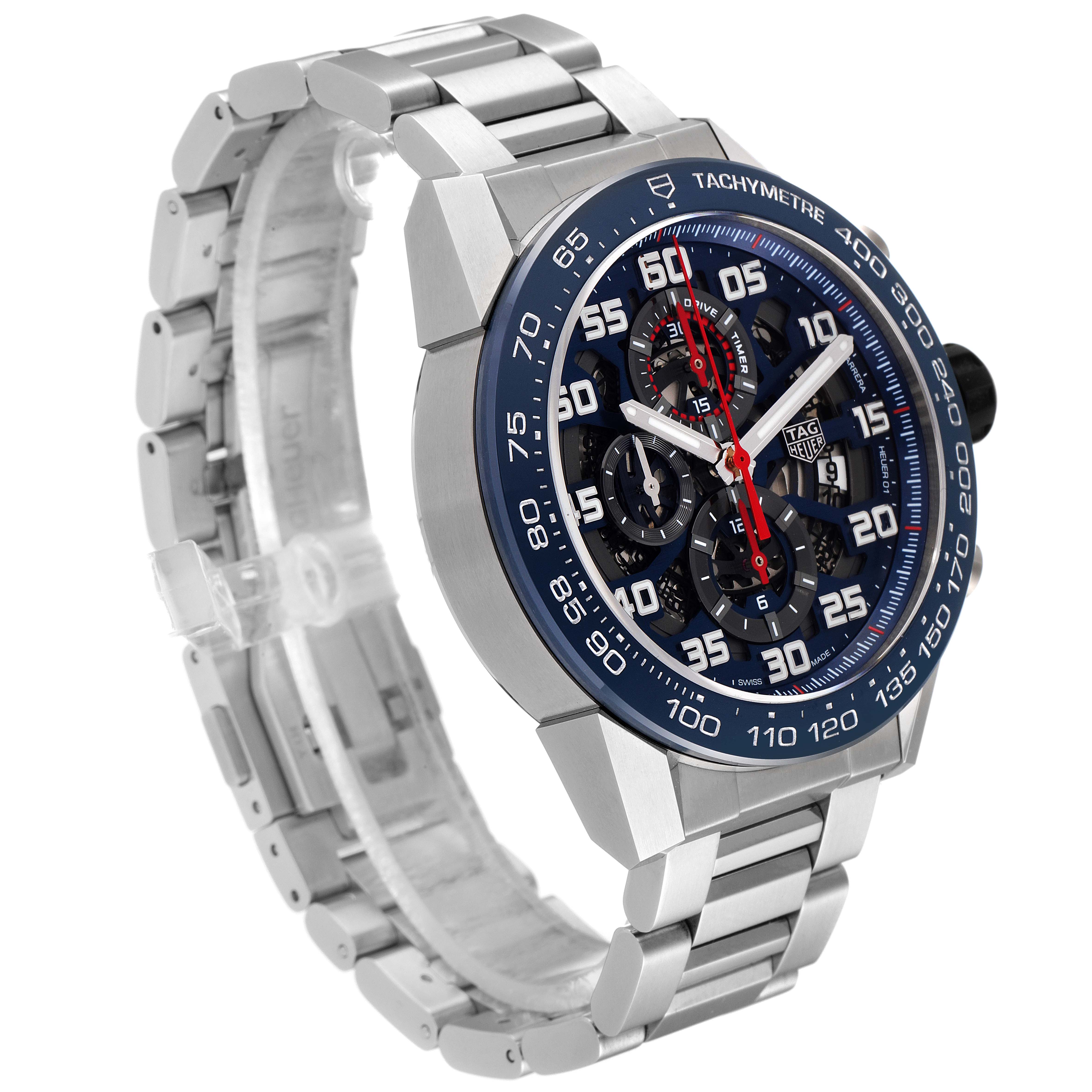 The image shows a Tag Heuer Carrera CAR2A1K.BA0703 Men
s Stainless Steel Blue Dial CAR2A1K.BA0703 Men
s Stainless Steel Blue Dial watch from a three-quarter angle, highlighting its face, bezel, and metal bracelet.