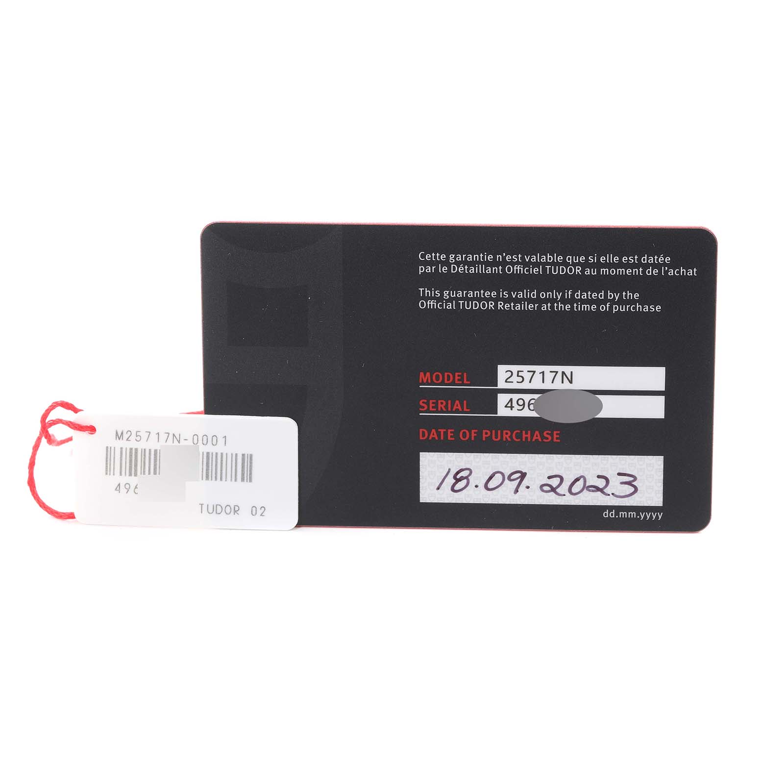 The image shows the warranty card and tag for a Tudor Pelagos M25717N-0001 Men
s Titanium Black Dial M25717N-0001 Men
s Titanium Black Dial model 25717N.