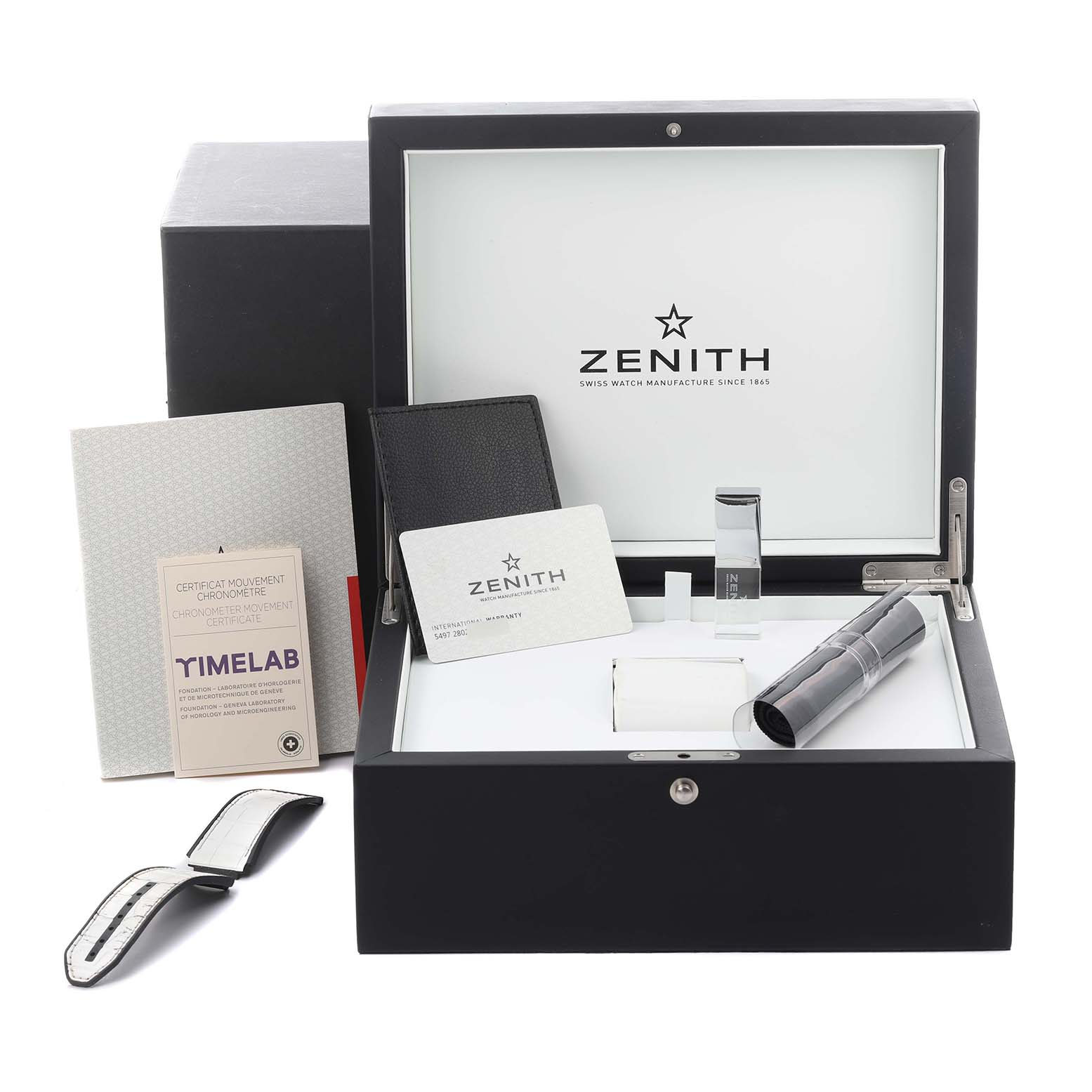 The image shows a Zenith Defy 95.9003.9004/78.R588 Men's Titanium Transparent Dial 95.9003.9004/78.R588 Men's Titanium Transparent Dial watch box set with accessories, including booklets, a strap, a cardholder, and a tool.