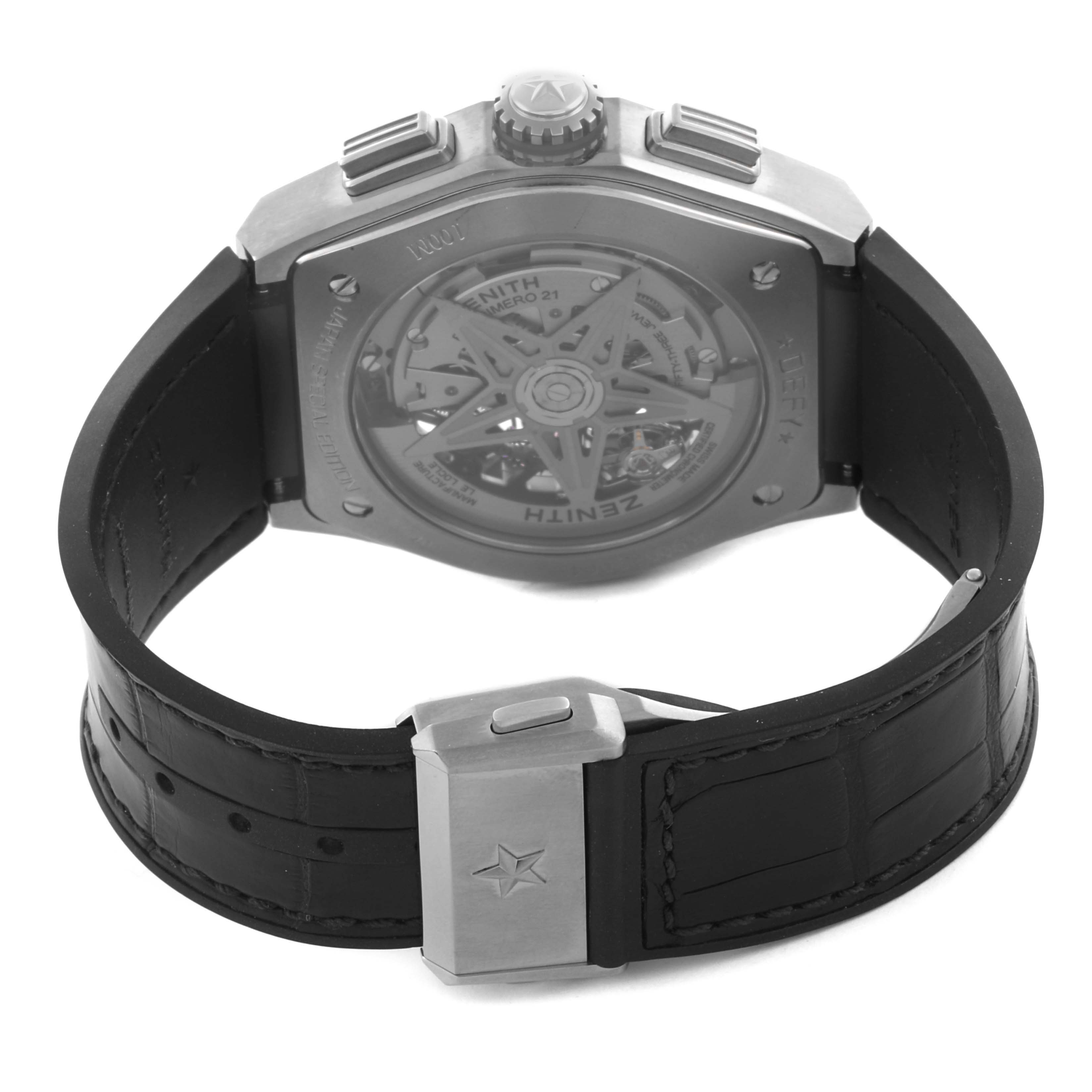 The image shows a Zenith Defy 95.9003.9004/78.R588 Men's Titanium Transparent Dial 95.9003.9004/78.R588 Men's Titanium Transparent Dial watch from the back, highlighting its transparent case back and black leather strap with a clasp.