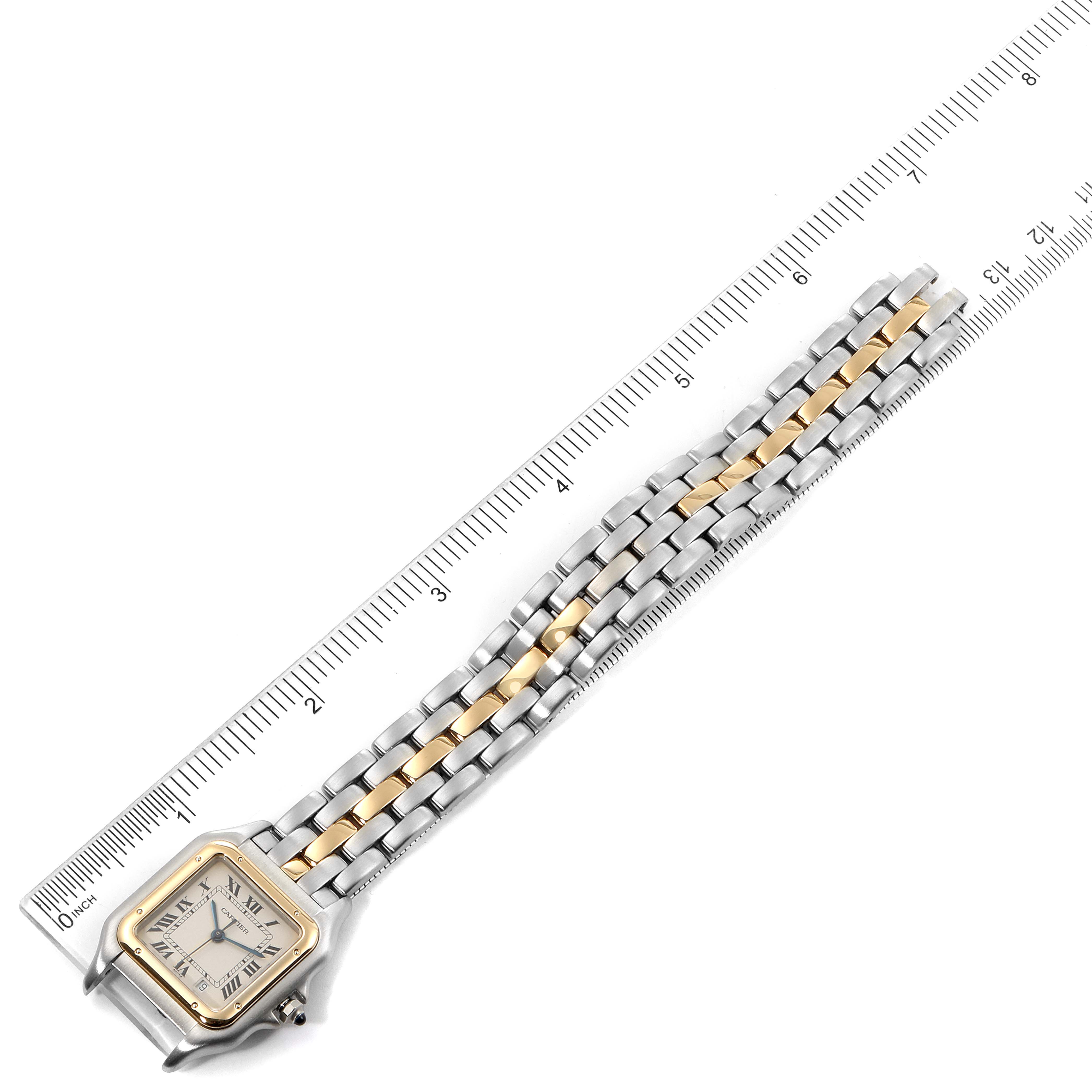 The image shows a Panthere model watch by Cartier from a top-down angle, highlighting its two-tone bracelet against a ruler.