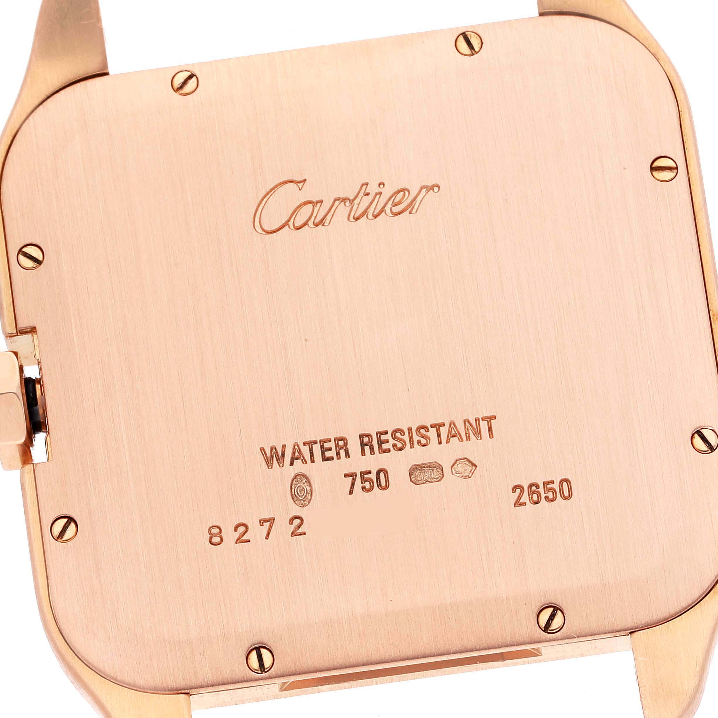 The image shows the back of the Santos Dumont watch by Cartier, highlighting the brand engraving and water-resistant markers.