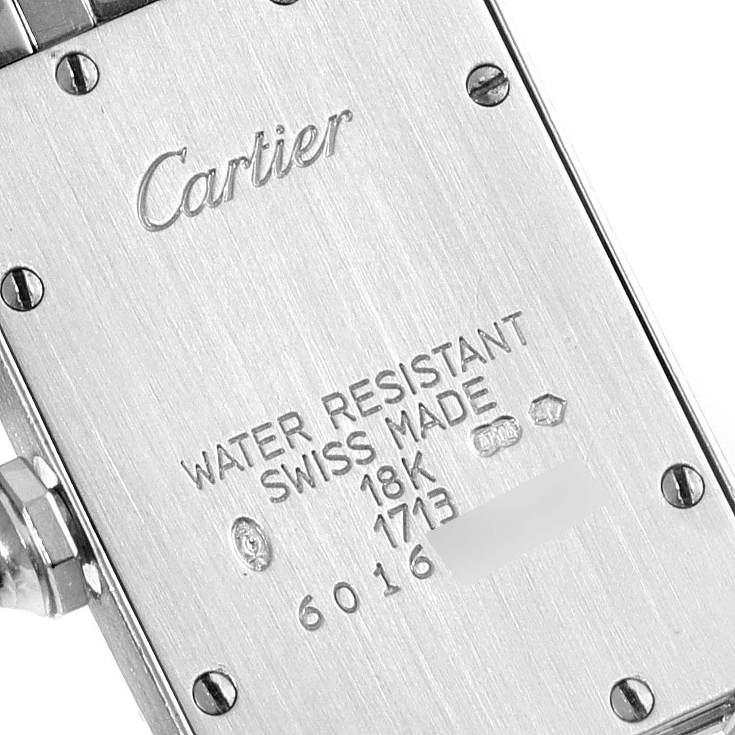 This image shows the back case of a Cartier Tank Américaine watch, detailing its water resistance, material, and serial numbers.