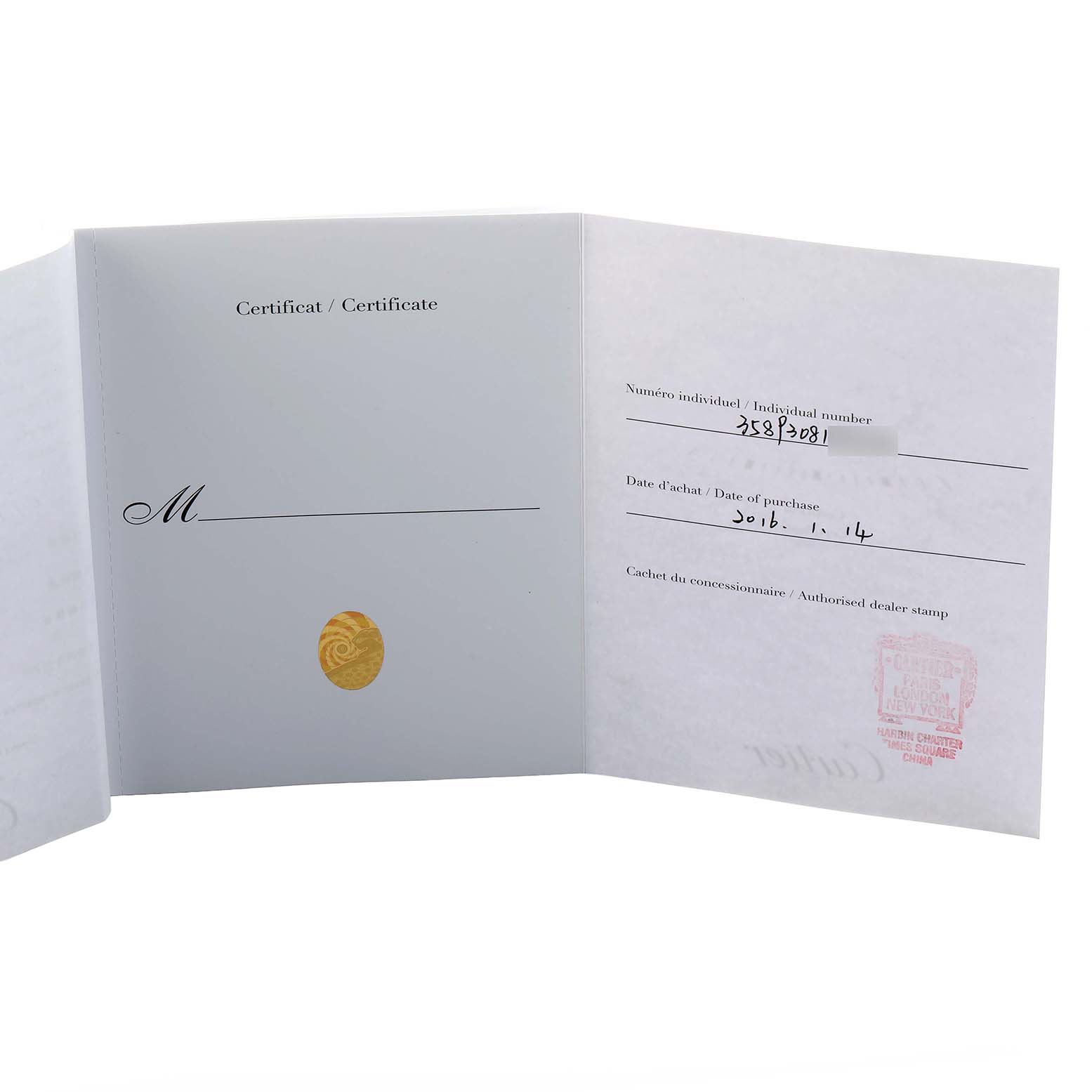 This image shows the warranty certificate for a Cartier Tank MC WSTA0010 Men's Stainless Steel Blue Dial watch, displaying purchase details and dealer stamp.