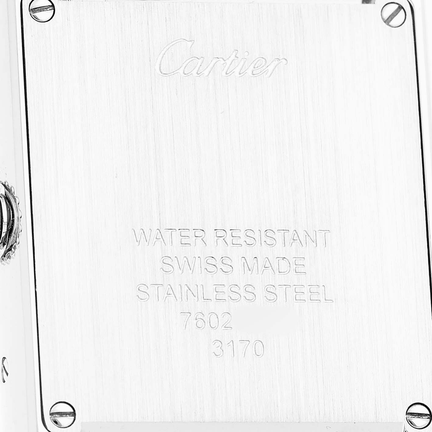 The image shows the back case of a Cartier Tank Solo WSTA0030 Women's Stainless Steel Silver Dial watch, featuring brand engravings and specifications.