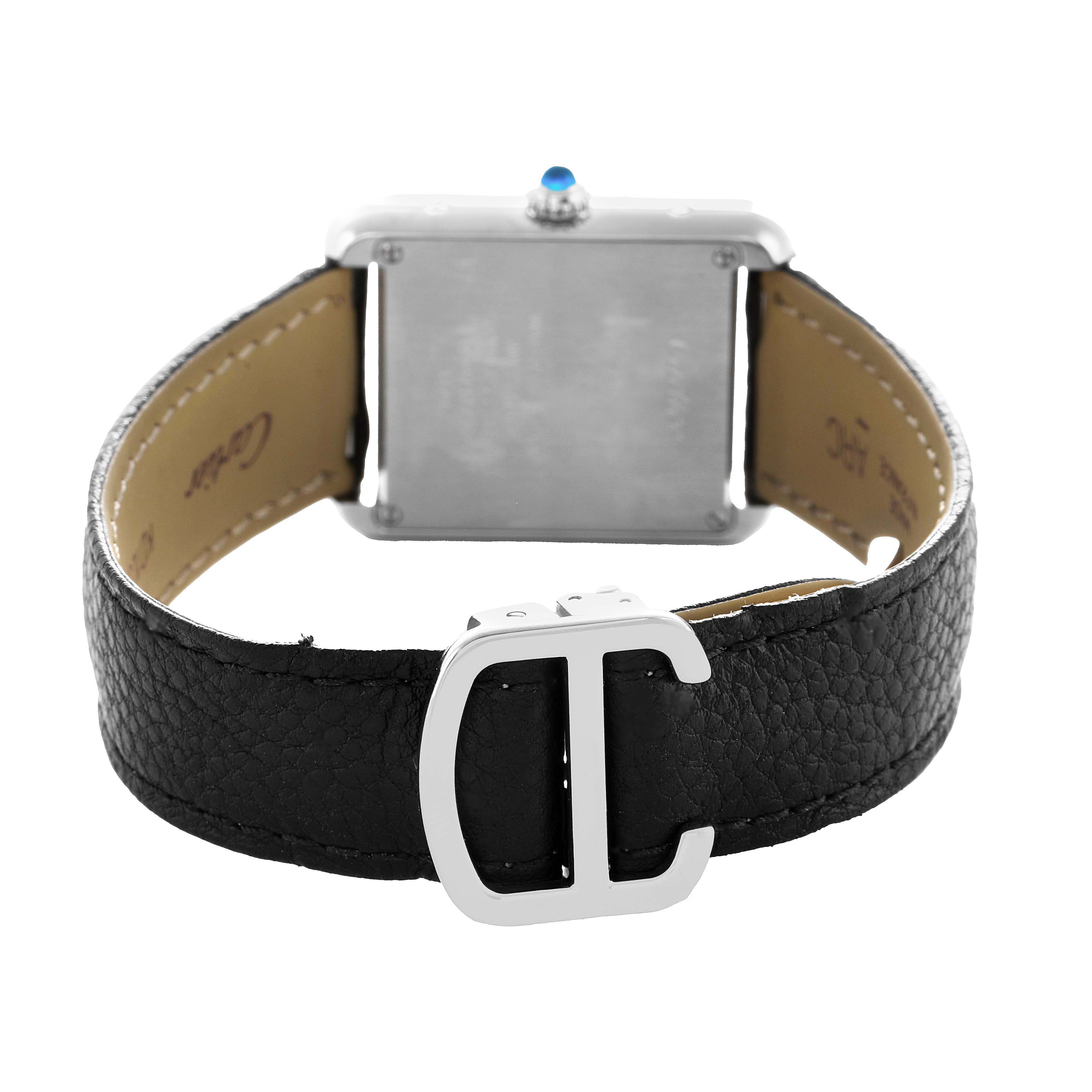 The Cartier Tank Solo WSTA0030 Women's Stainless Steel Silver Dial watch is shown from the back, highlighting the leather strap and buckle.