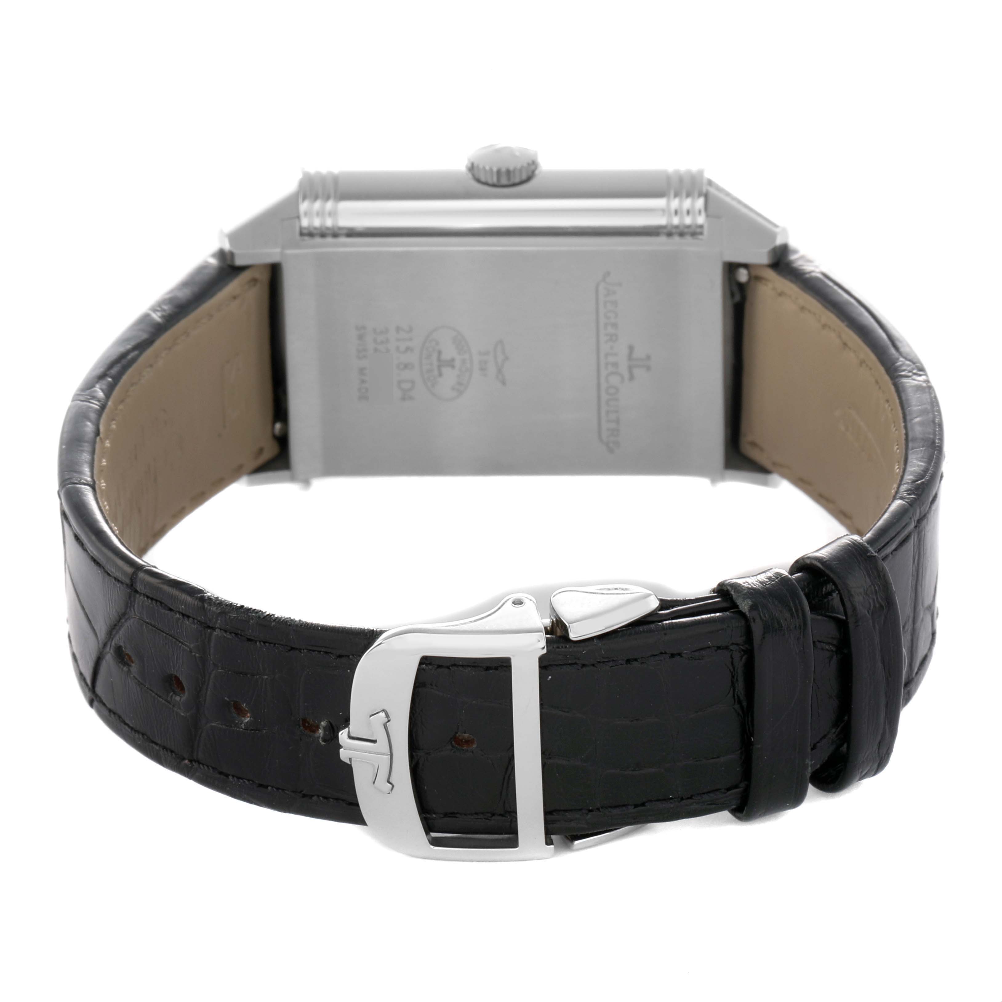 The image shows the reverse side of a Jaeger-LeCoultre Reverso watch, highlighting the clasp and leather strap.