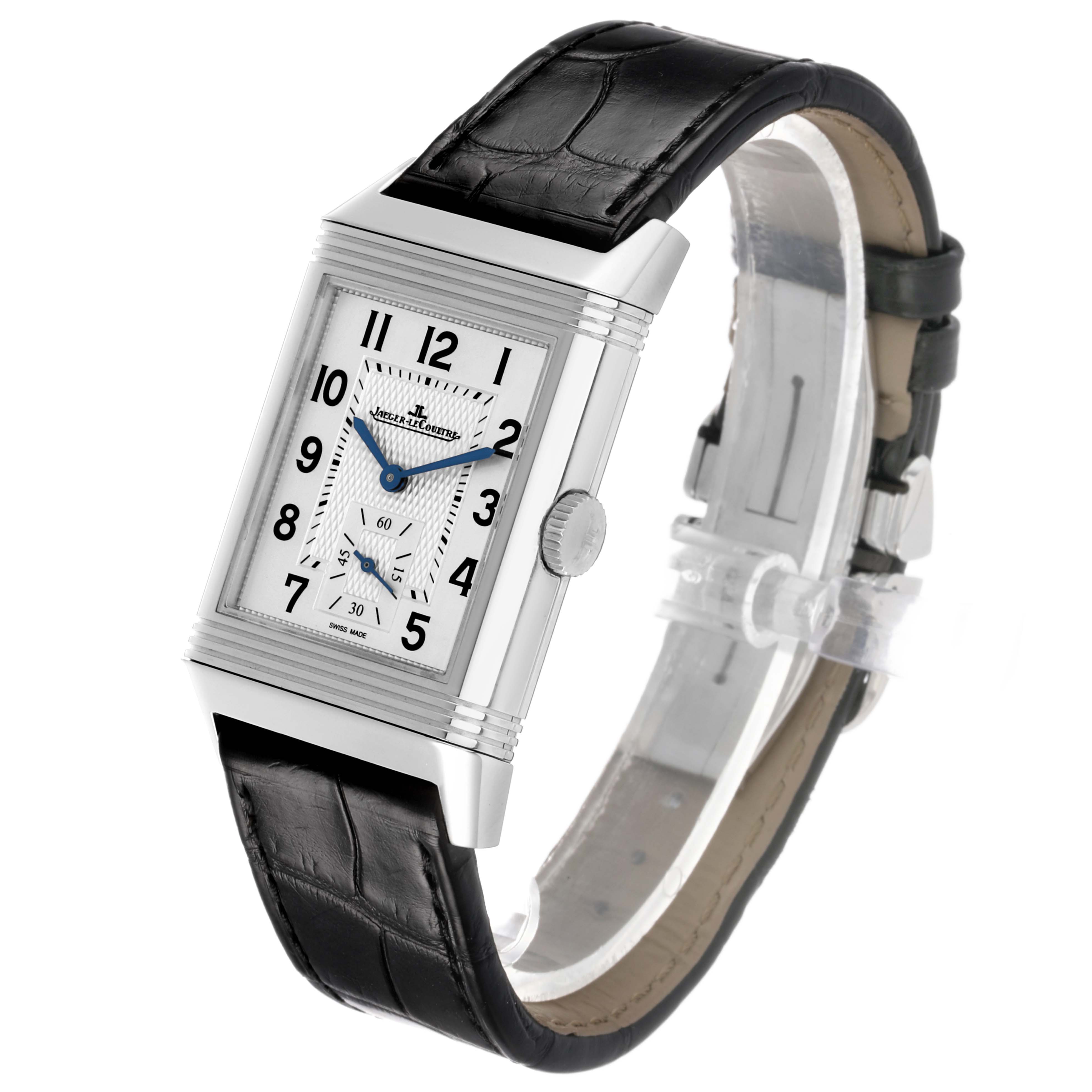 The Jaeger-LeCoultre Reverso watch is shown at an angled view, displaying the dial, case, crown, and leather strap.