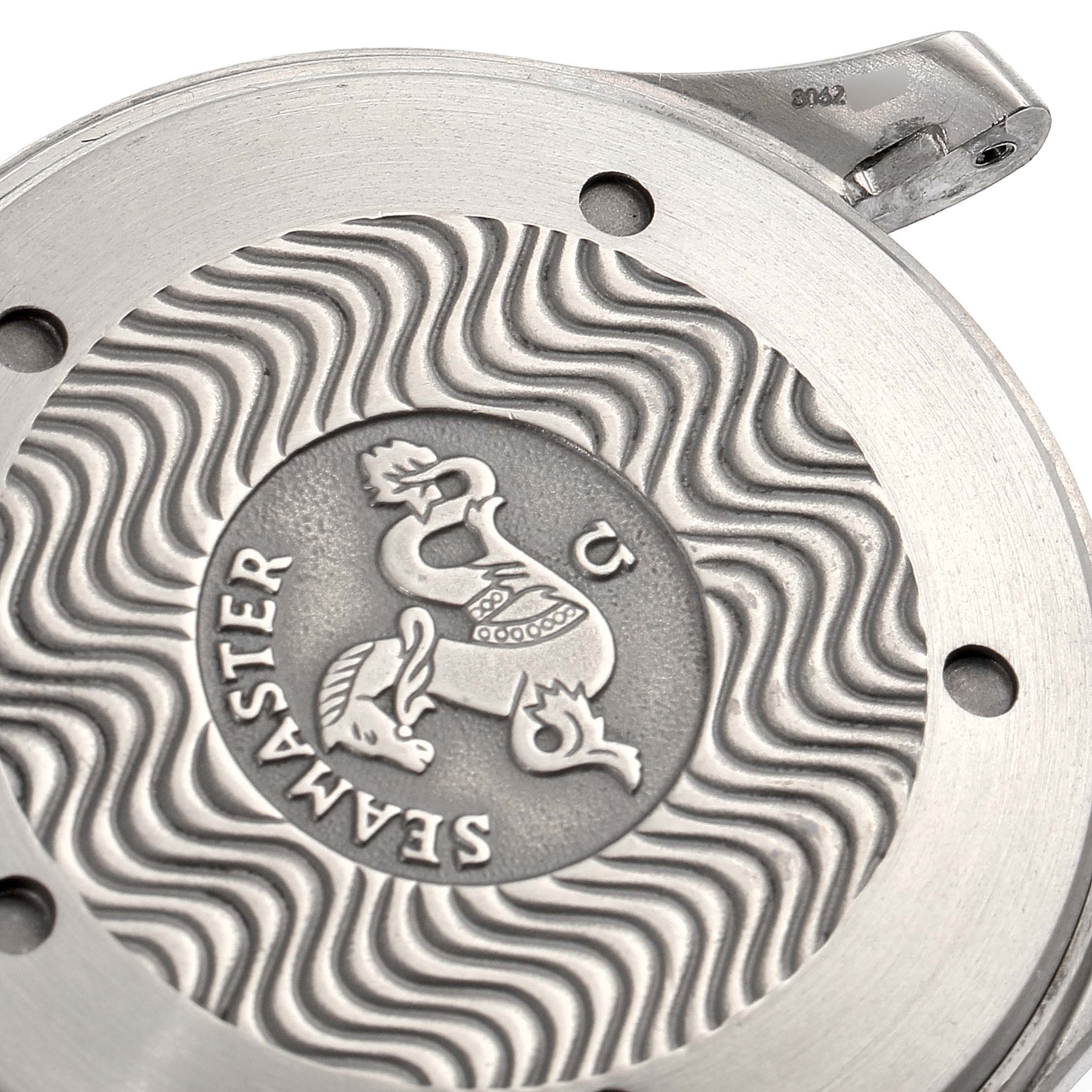 This image shows a close-up of the case back of an Omega Seamaster 2231.80.00 Men's Titanium Blue Dial 2231.80.00 Men's Titanium Blue Dial watch, highlighting its engraved logo and wavy pattern.