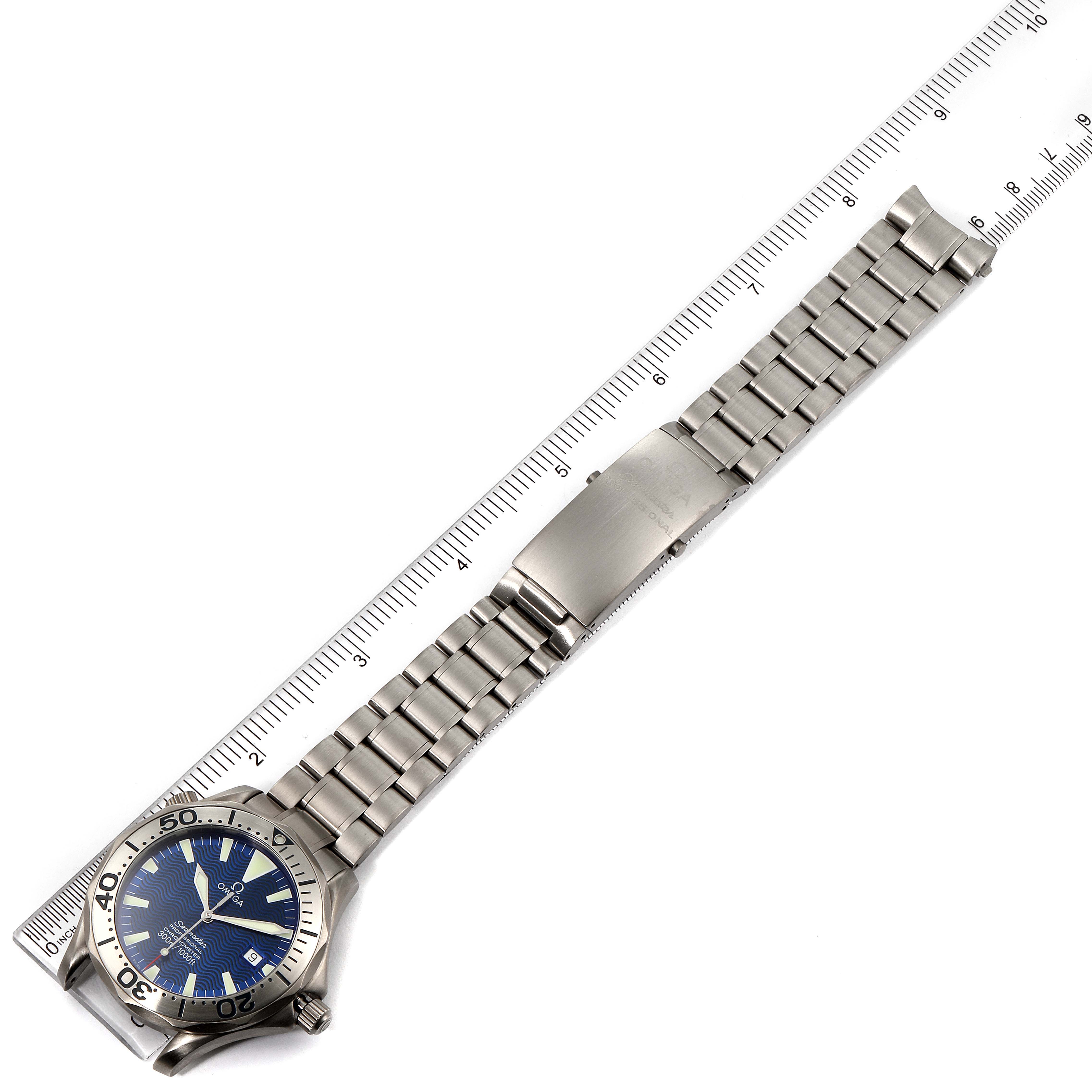 The image shows the Omega Seamaster 2232.80.00 Men's Titanium Blue Dial 2232.80.00 Men's Titanium Blue Dial watch in a top-down view displaying the face, bezel, and the entire metal bracelet with a ruler for scale.