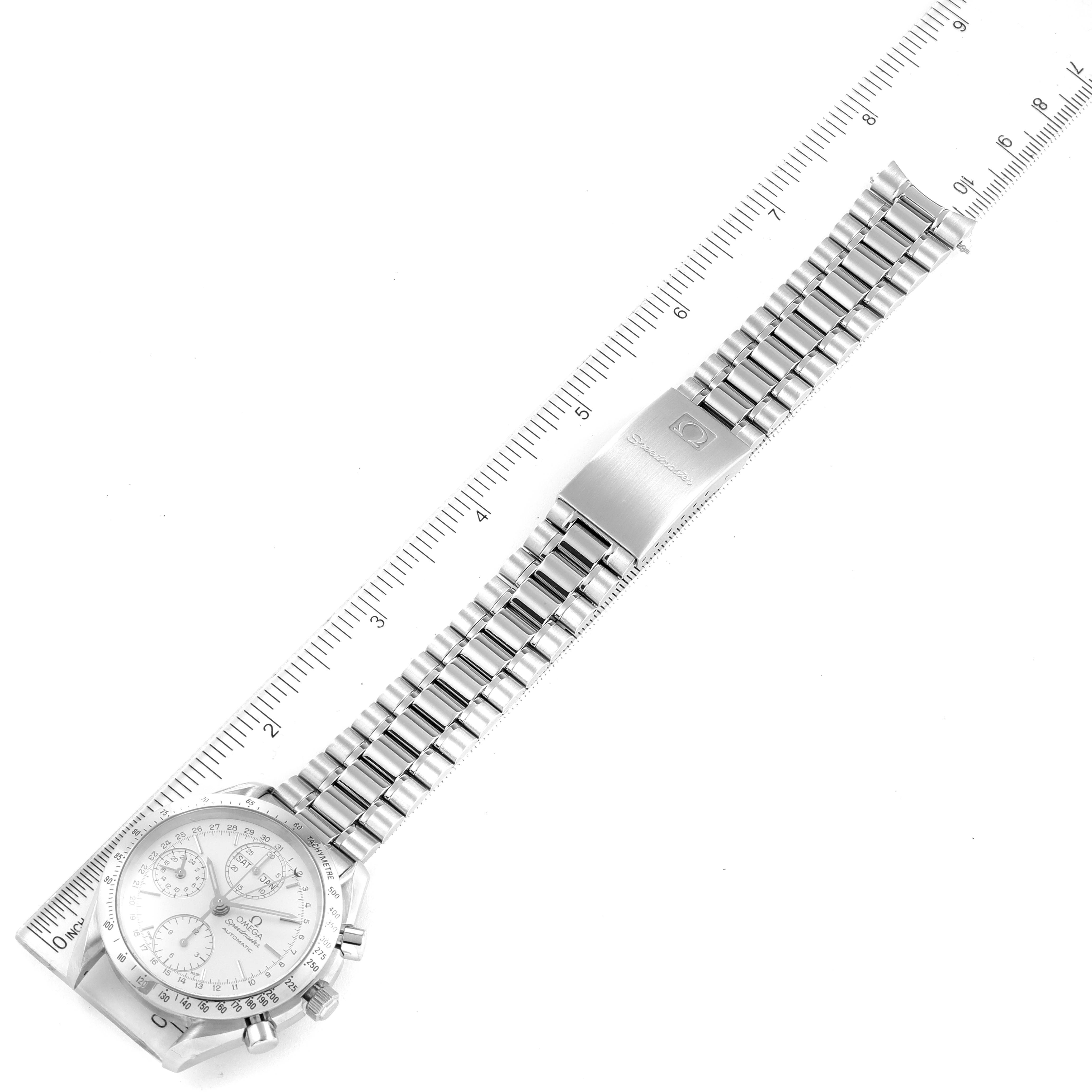 The image shows an Omega Speedmaster 3521.30.00 Men's Stainless Steel Silver Dial 3521.30.00 Men's Stainless Steel Silver Dial watch laid flat, highlighting its stainless steel bracelet and clasp beside a ruler.